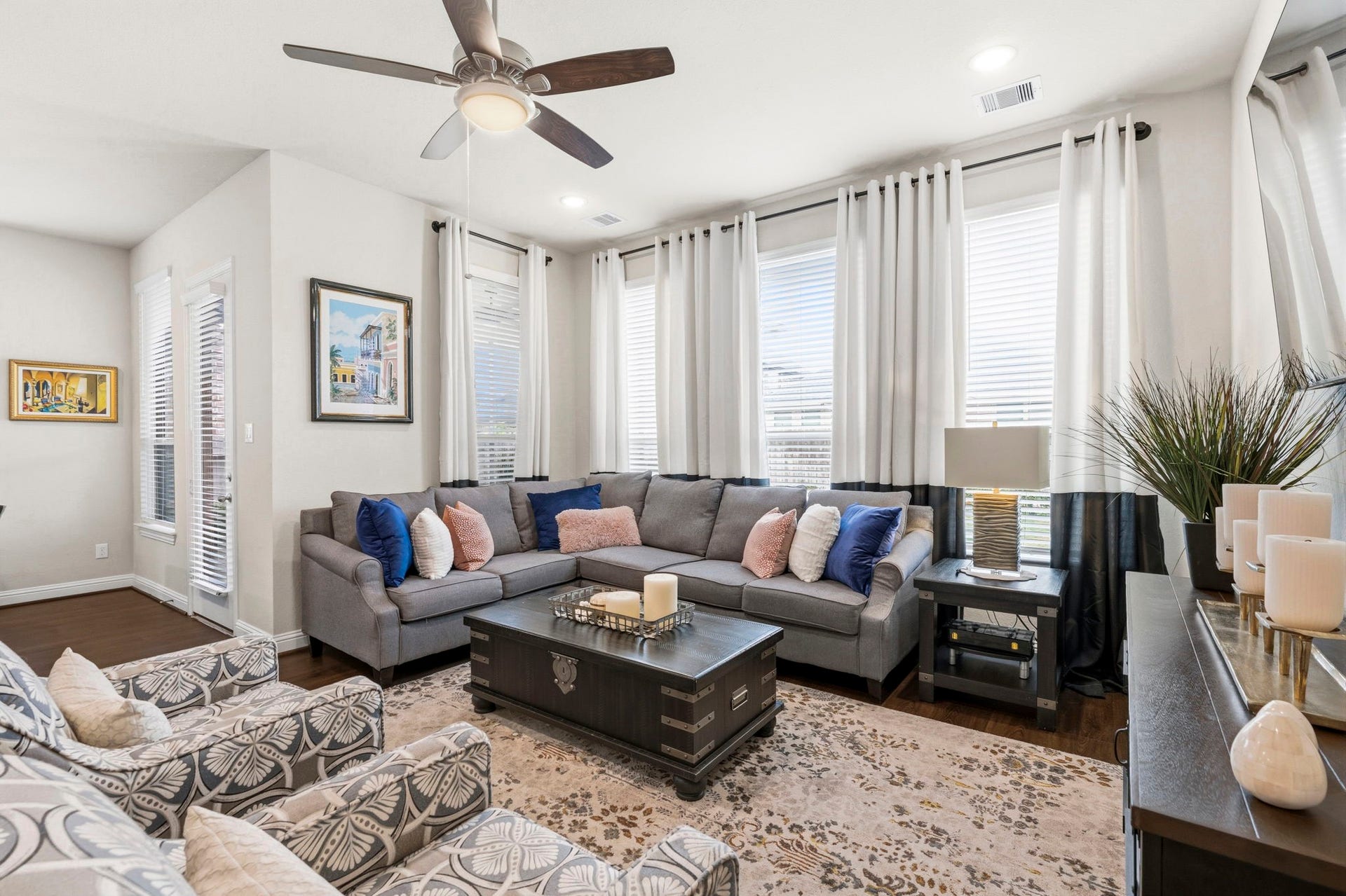 17209 Olive Blossom Court, Conroe, TX 77385 Wall of windows fills the space with natural light, enhancing the bright and inviting feel of the family room.