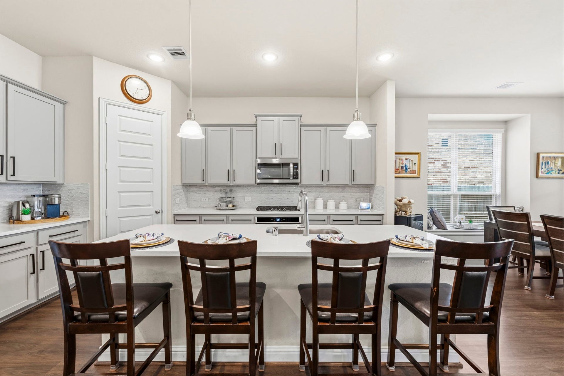 17209 Olive Blossom Court, Conroe, TX 77385 Expansive island serves as the heart of the kitchen, offering generous space for casual dining and entertaining, complemented by quartz countertops.