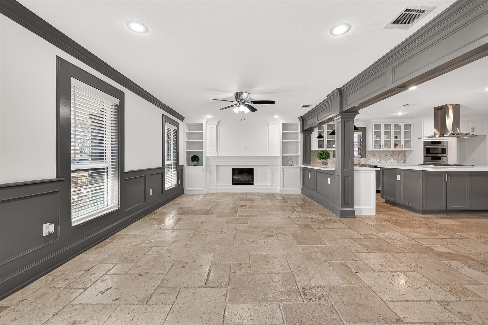 10054 Cedardale Drive, Houston, TX 77055 Features include a ceiling fan, built-in shelving, and a charming fireplace, creating a cozy yet elegant atmosphere.