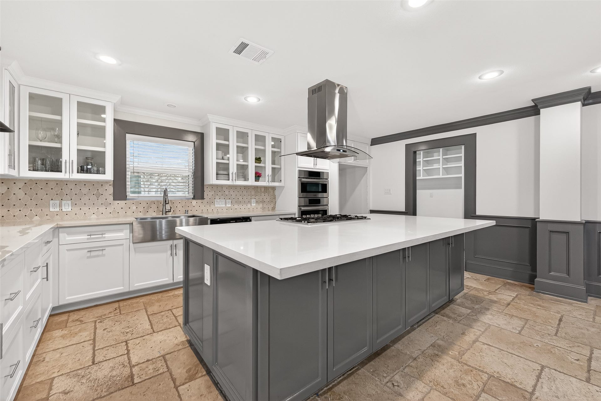10054 Cedardale Drive, Houston, TX 77055 It includes stainless steel appliances, ample storage, and a stylish range hood.