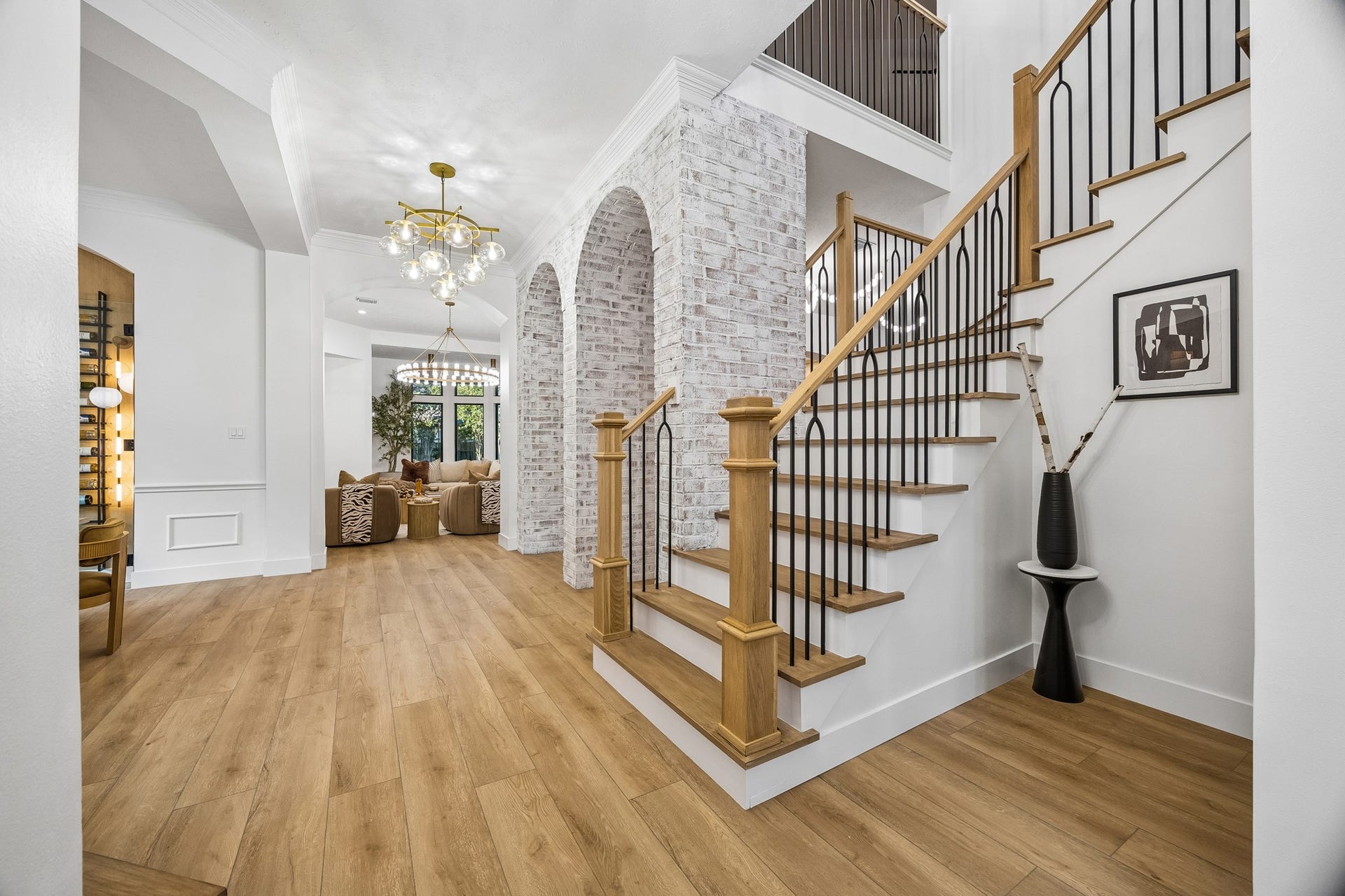 34 N Lansdowne Circle, The Woodlands, TX 77382 Wide open foyer with a peak at the stone arches sets the tone for the home