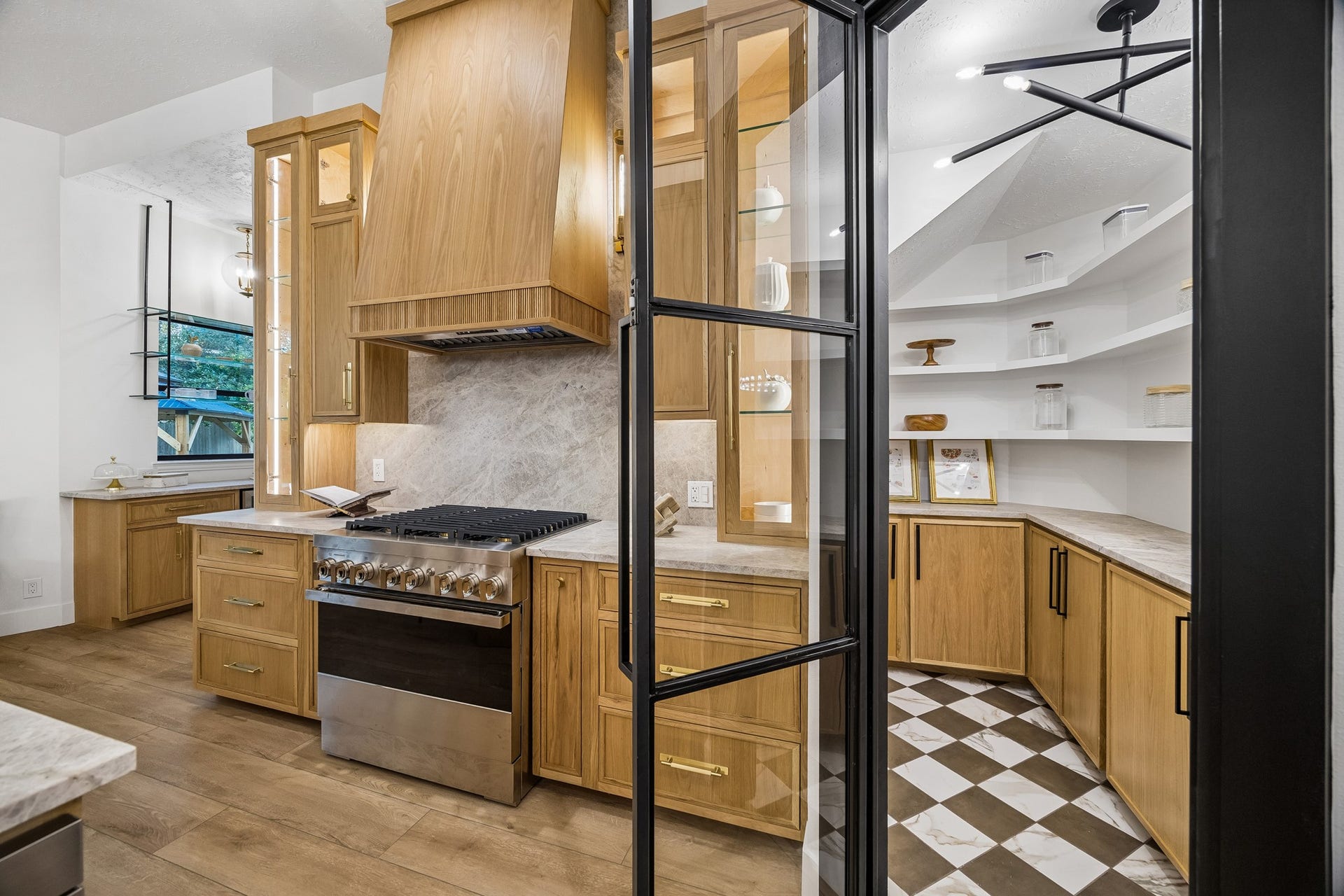 34 N Lansdowne Circle, The Woodlands, TX 77382 A custom walk-in pantry with cabinets and floating shelving