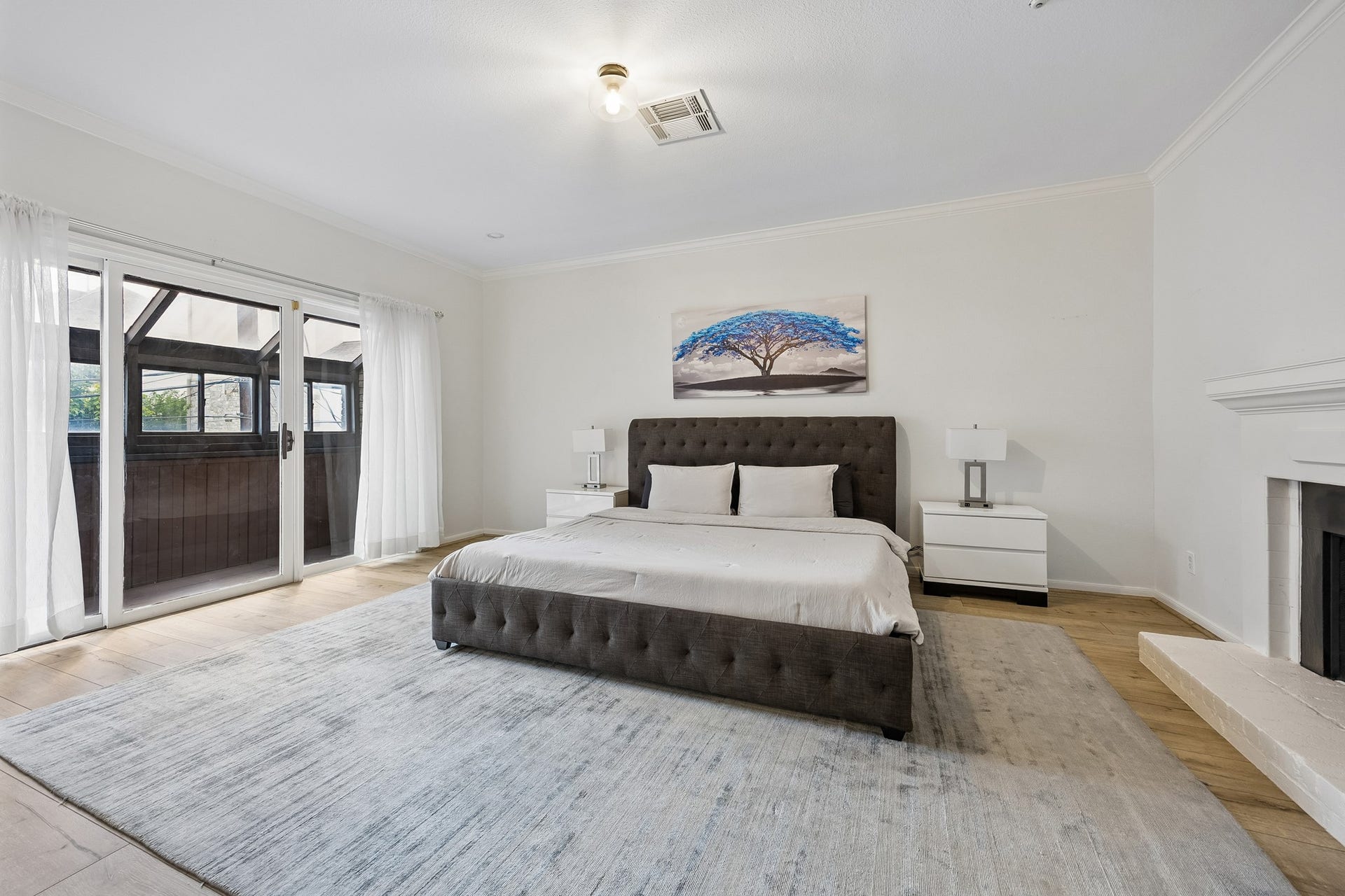 2524 Nantucket Drive, #C, Houston, TX 77057 Primary bedroom with sunroom and wood burning fireplace.