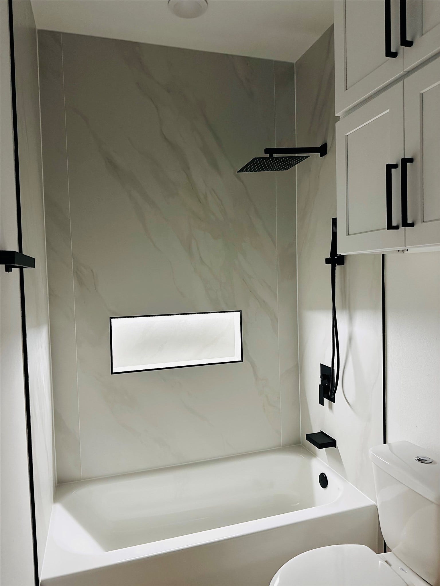 4607 Bricker Street, #A B C, Houston, TX 77051 Illuminated extra large soap niche surrounded by 4ft x 8ft slabs of high end porcelain tile.