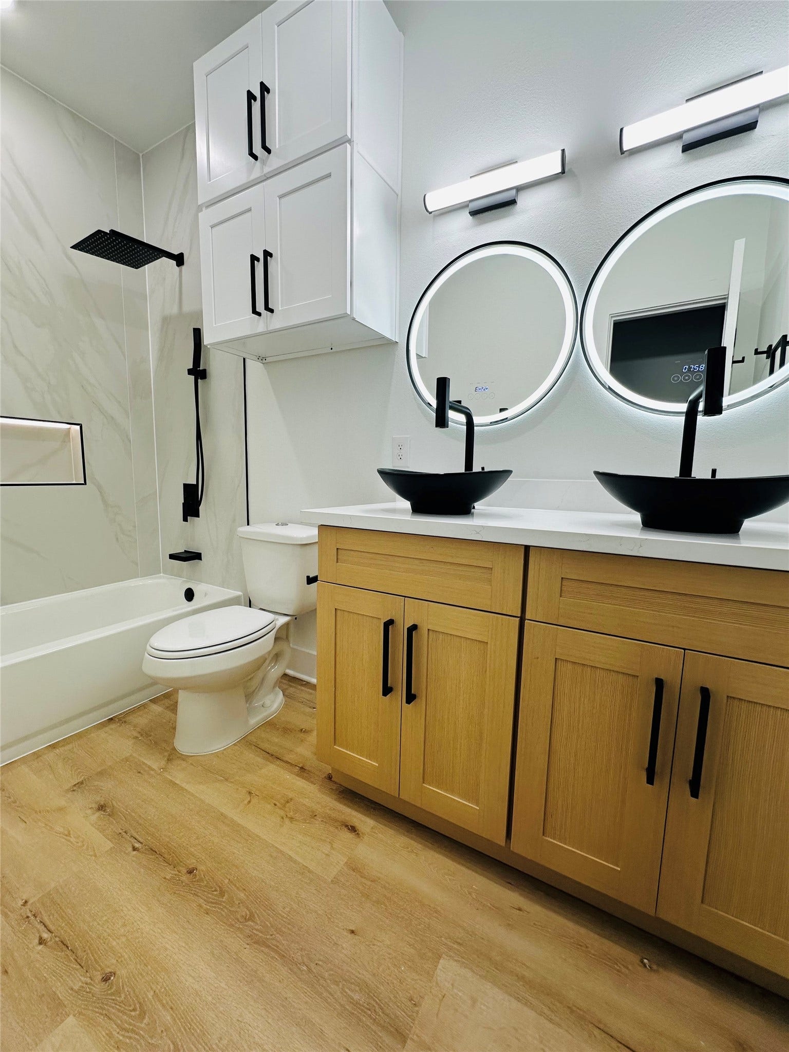 4607 Bricker Street, #A B C, Houston, TX 77051 bathrooms feature 4ft x 9ft porecilan tile wall slabs, push button toilets, matte black hardware, matte black pull out multi function vanity faucets, multi color led mirros, double stacked head knocker cabinets, illuminated soap niches, upgraded shower faucets with hand held sprayer, and more.
