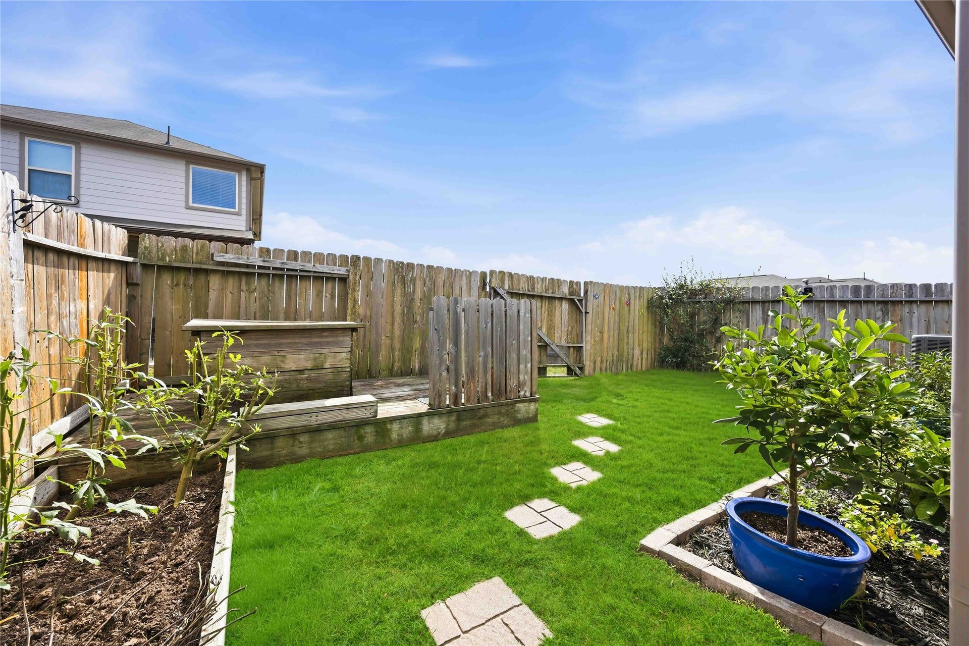 6420 Innsbruck Meadows Lane, Houston, TX 77048 Backyard with raised beds and fruit trees.