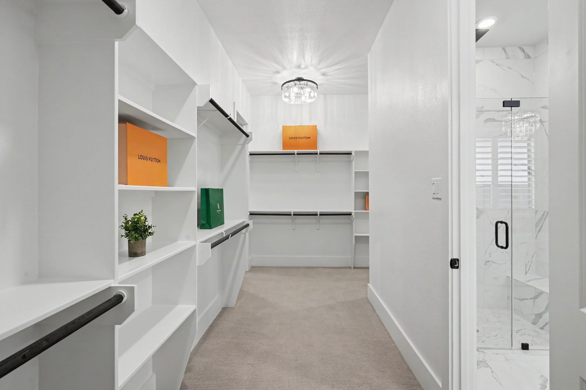27720 Hazelbrook Lane, Spring, TX 77386 Your MASSIVE Primary Bedroom Closet conveniently has a door connecting to your Laundry Room. As you turn the corner to the right, there is an additional hallway of closet space with custom built-ins.