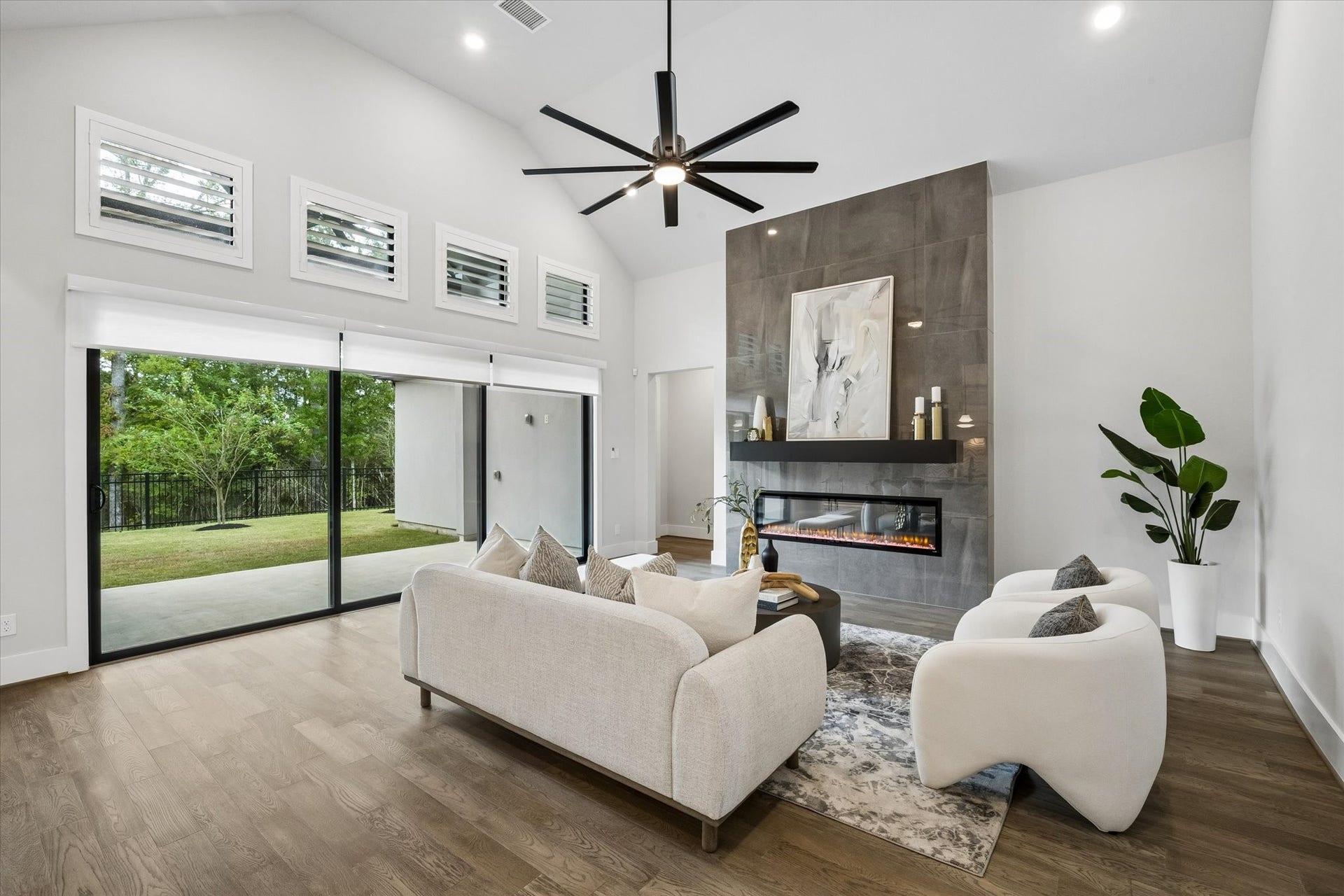27720 Hazelbrook Lane, Spring, TX 77386 Your Living Room features STUNNING Modern Glass Sliding Doors, Motorized Roller Shades and additional windows with Plantation Shutters. Your High-End Electric Fireplace elevates the entire room creating the perfect ambience