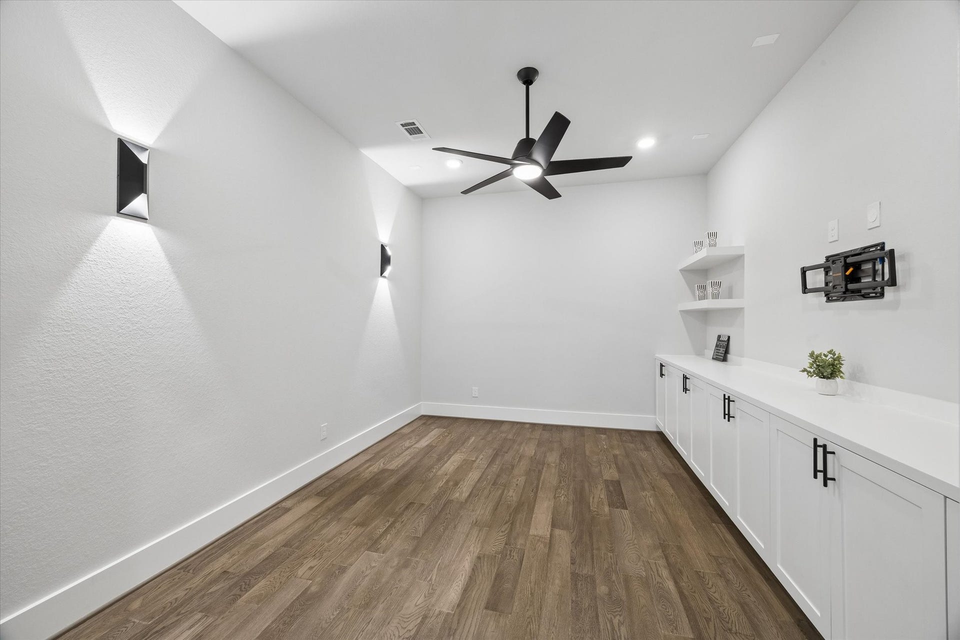 27720 Hazelbrook Lane, Spring, TX 77386 Your additional MEDIA ROOM is set up with wall sconces, modern ceiling fan, recessed lighting, storage cabinets and floating wall shelves. The TV Wall Mount and outlet is already installed.