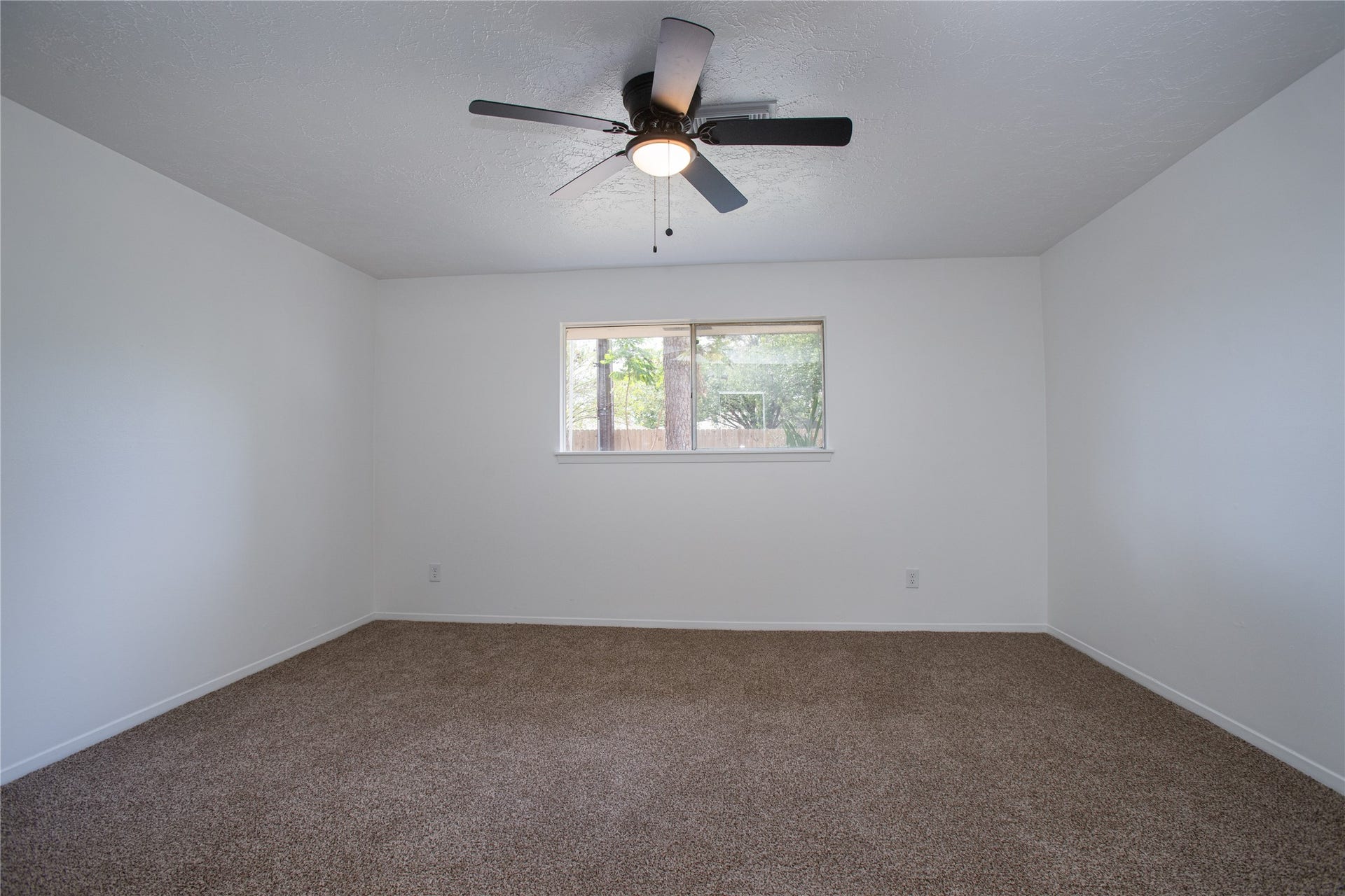 16131 Forest Way Drive, Houston, TX 77090 Spacious primary bedroom that has window access to the backyard.