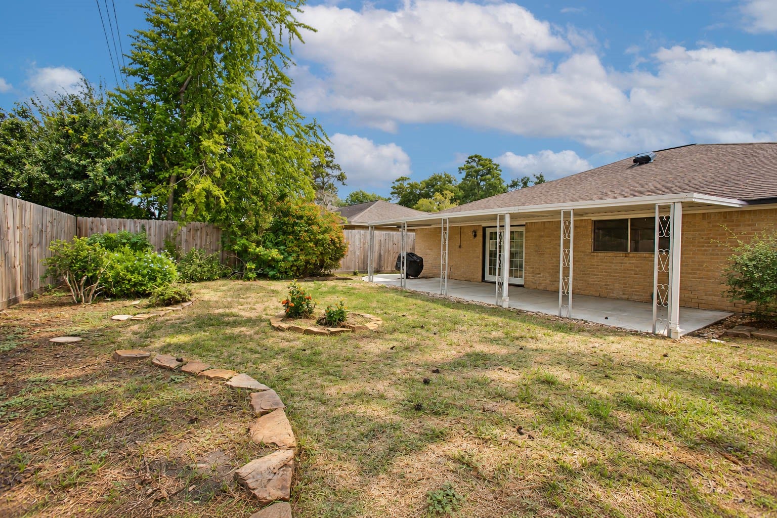 16131 Forest Way Drive, Houston, TX 77090 Lovely backyard with a covered patio and nice garden beds.