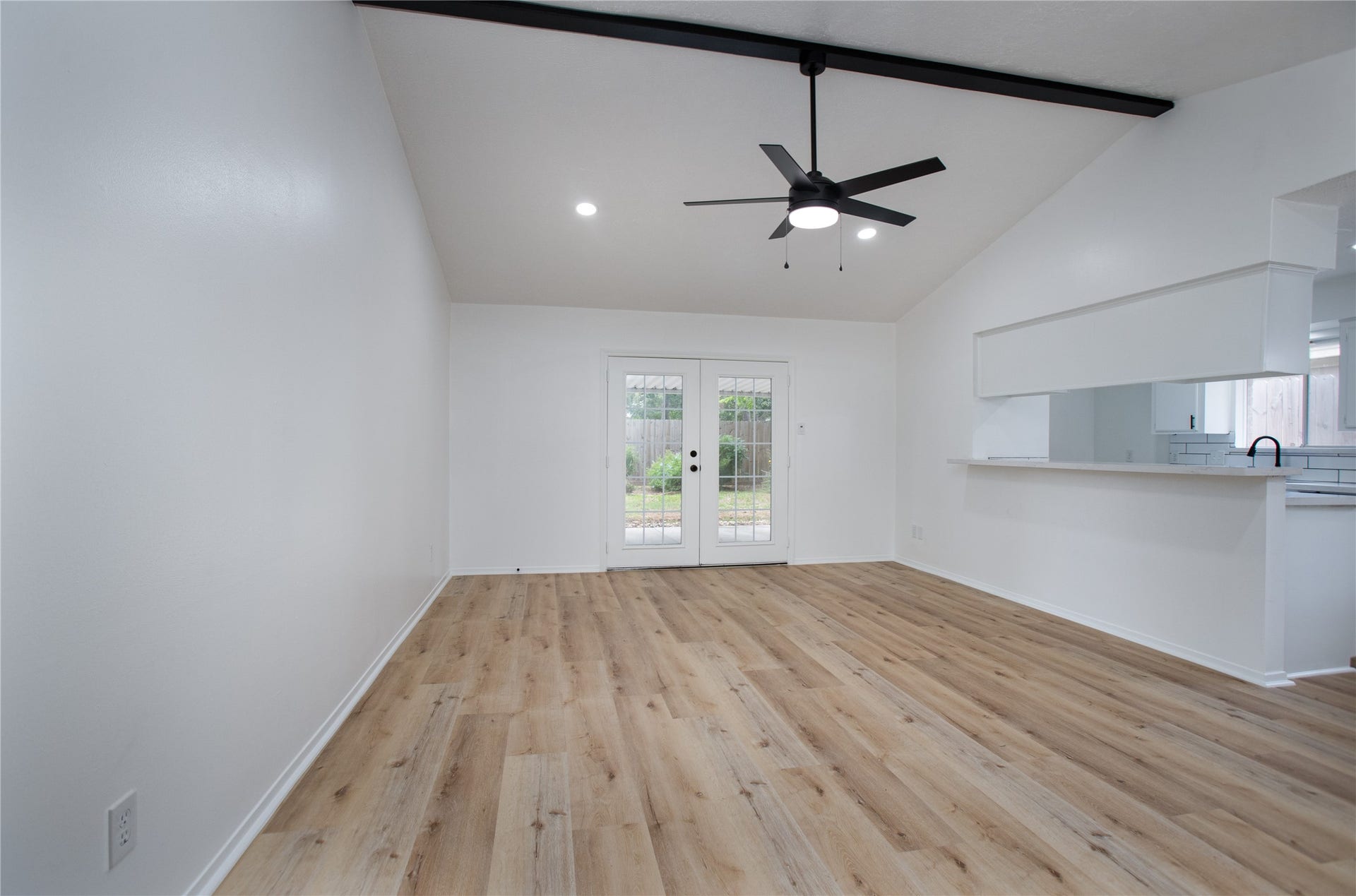 16131 Forest Way Drive, Houston, TX 77090 Living room with high ceilings and convenient access to the backyard through beautiful double doors.