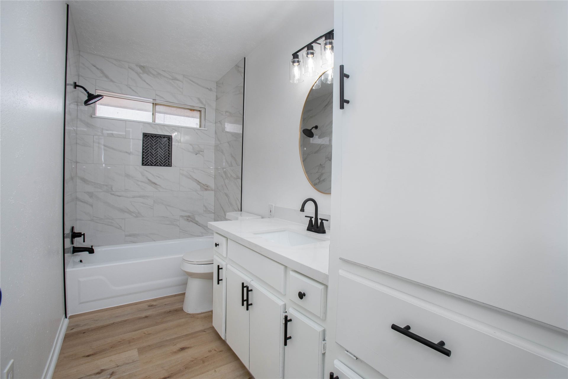 16131 Forest Way Drive, Houston, TX 77090 Wonderfully remodeled secondary bathroom that has new tile shower, hardware, and has much storage space.