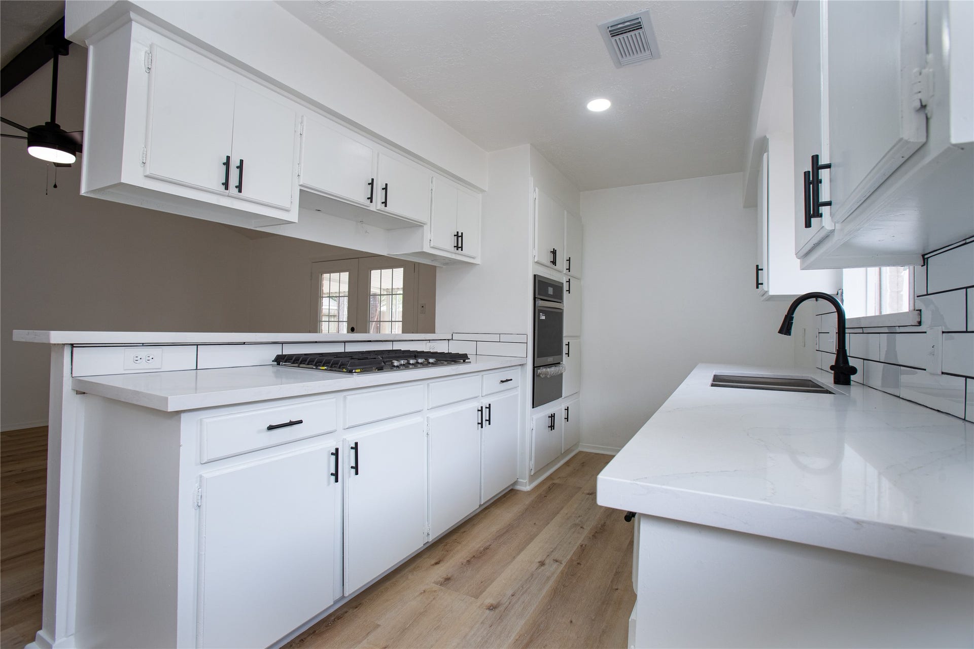 16131 Forest Way Drive, Houston, TX 77090 Remodeled kitchen with gas appliances, quartz countertops with new sink and hardware.