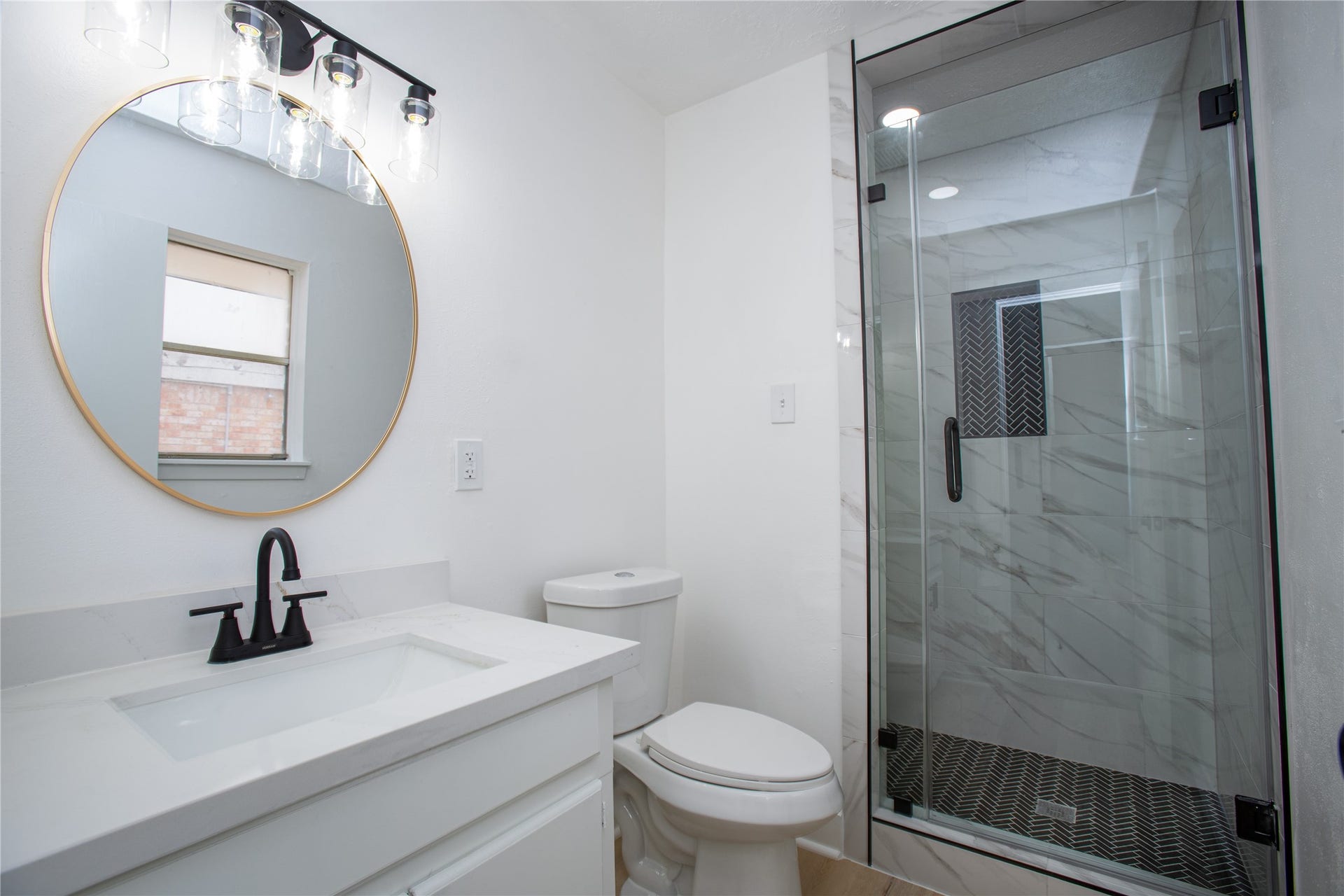 16131 Forest Way Drive, Houston, TX 77090 Beautifully remodeled primary bathroom that has a new tile shower, glass door, quartz countertops and new hardware.