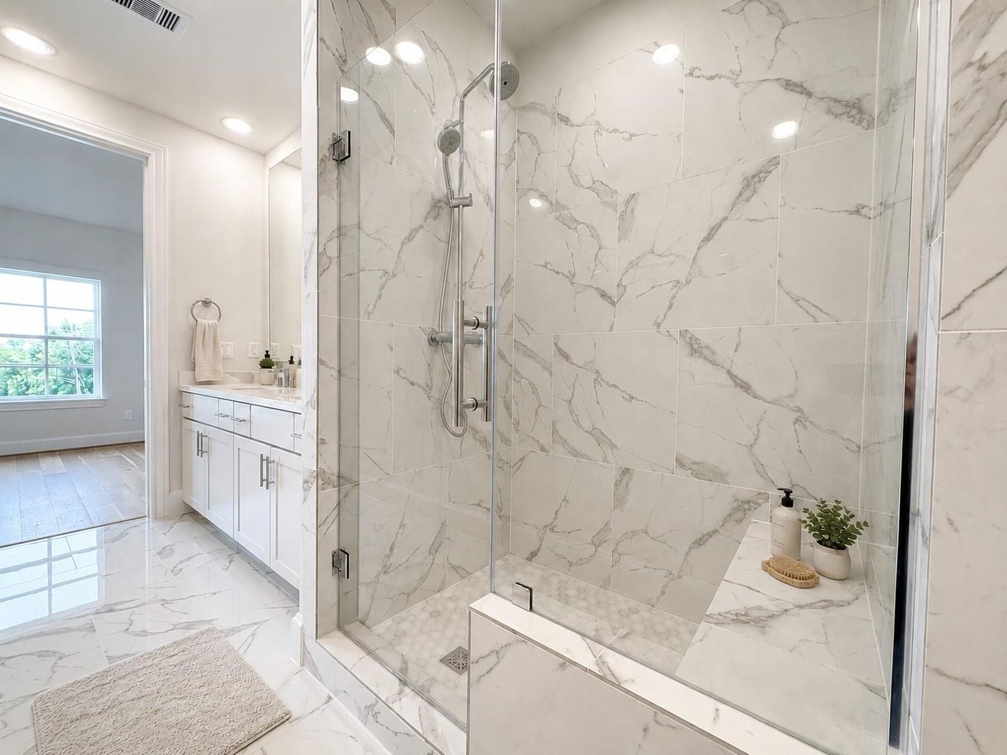741 Bringhurst Street, Houston, TX 77020 Primary bath with tall mirrors and large walk in shower with bench seat.