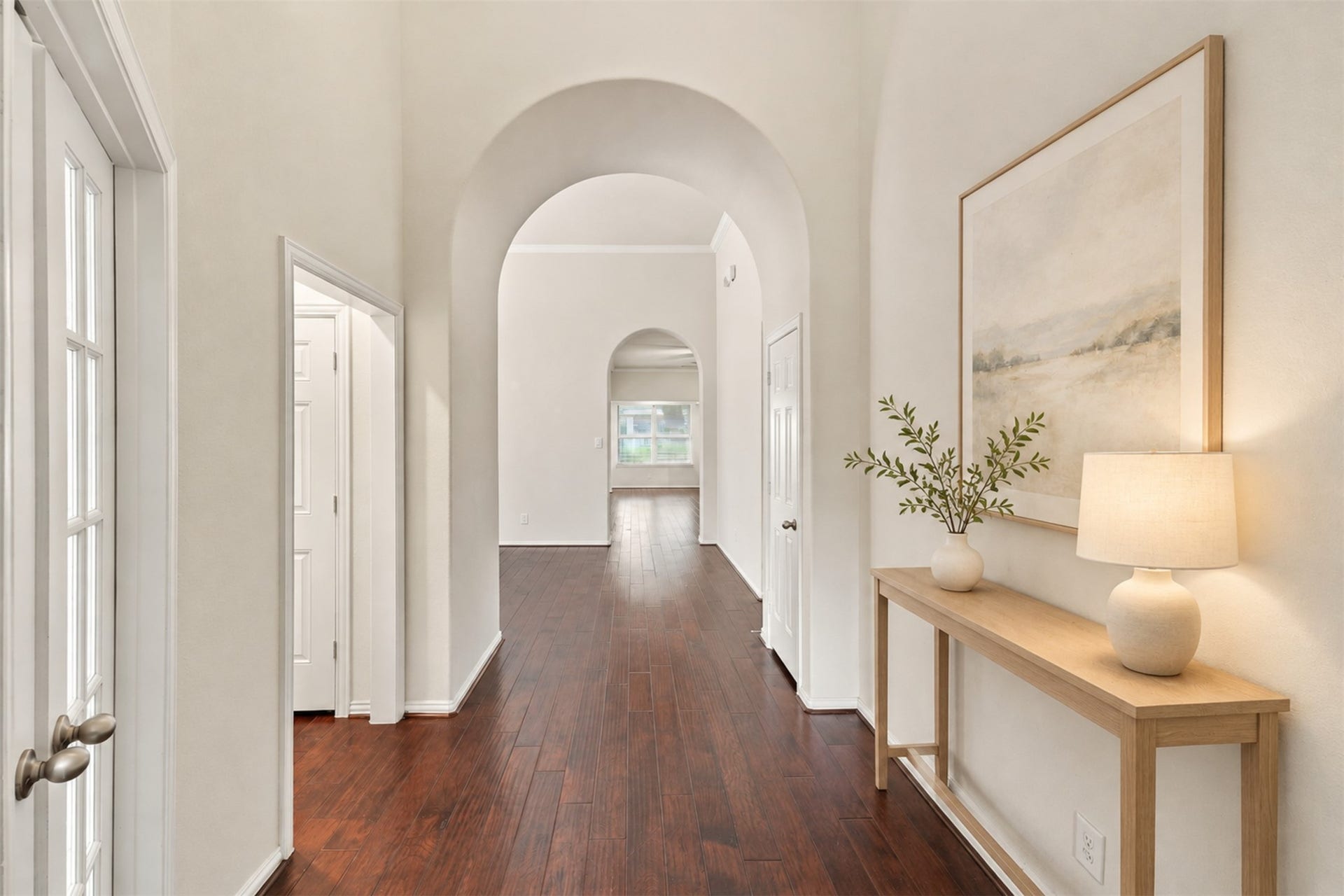 8319 Floating Heart Court, Conroe, TX 77385 An elegant entry framed by graceful arches, crown molding & rich hardwood floors. *virtually staged*