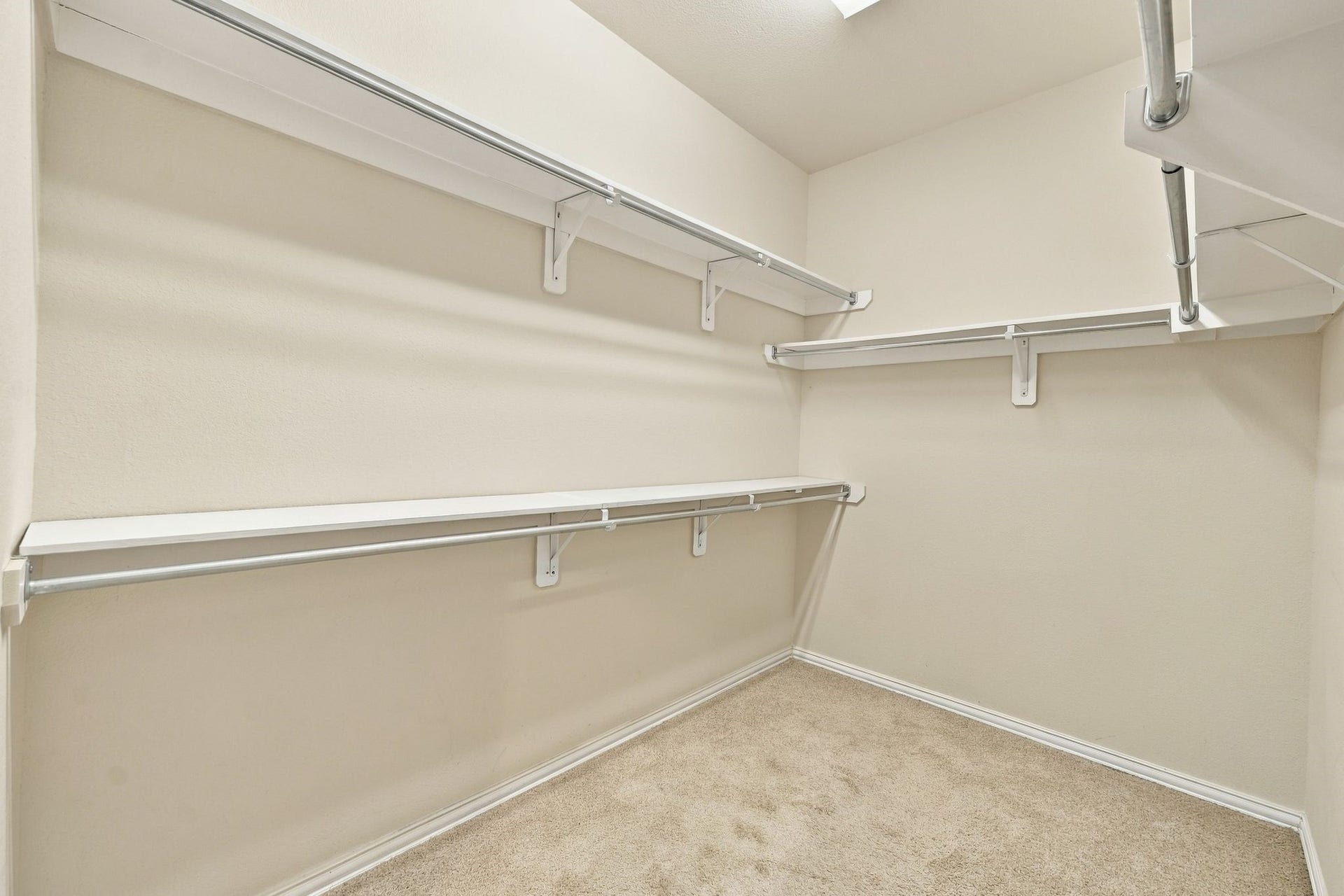 8319 Floating Heart Court, Conroe, TX 77385 Generous walk-in primary closet with built-in shelving and abundant hanging space.