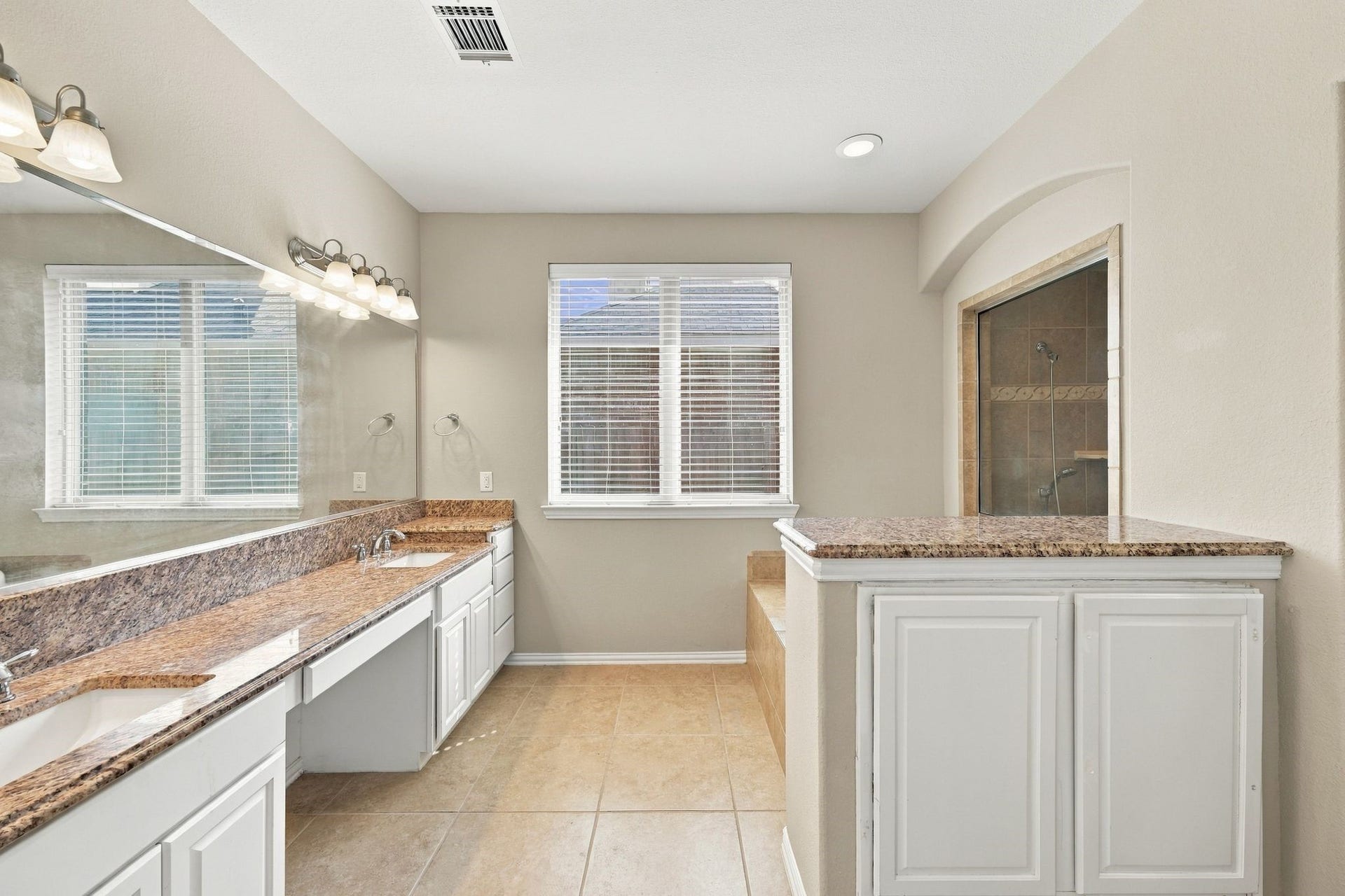 8319 Floating Heart Court, Conroe, TX 77385 Spacious primary bath with dual vanities, generous cabinetry & abundant natural light.