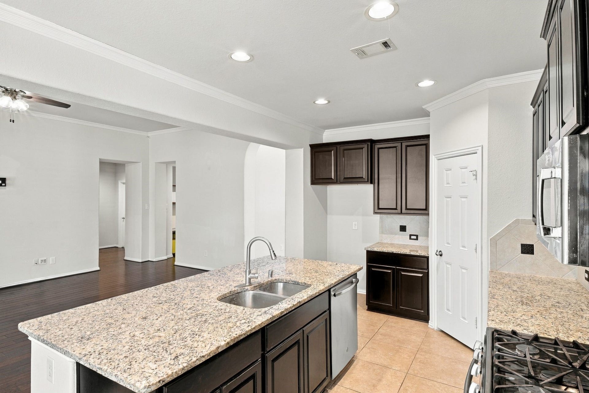 8319 Floating Heart Court, Conroe, TX 77385 An oversized island provides generous workspace and a natural gathering place.
