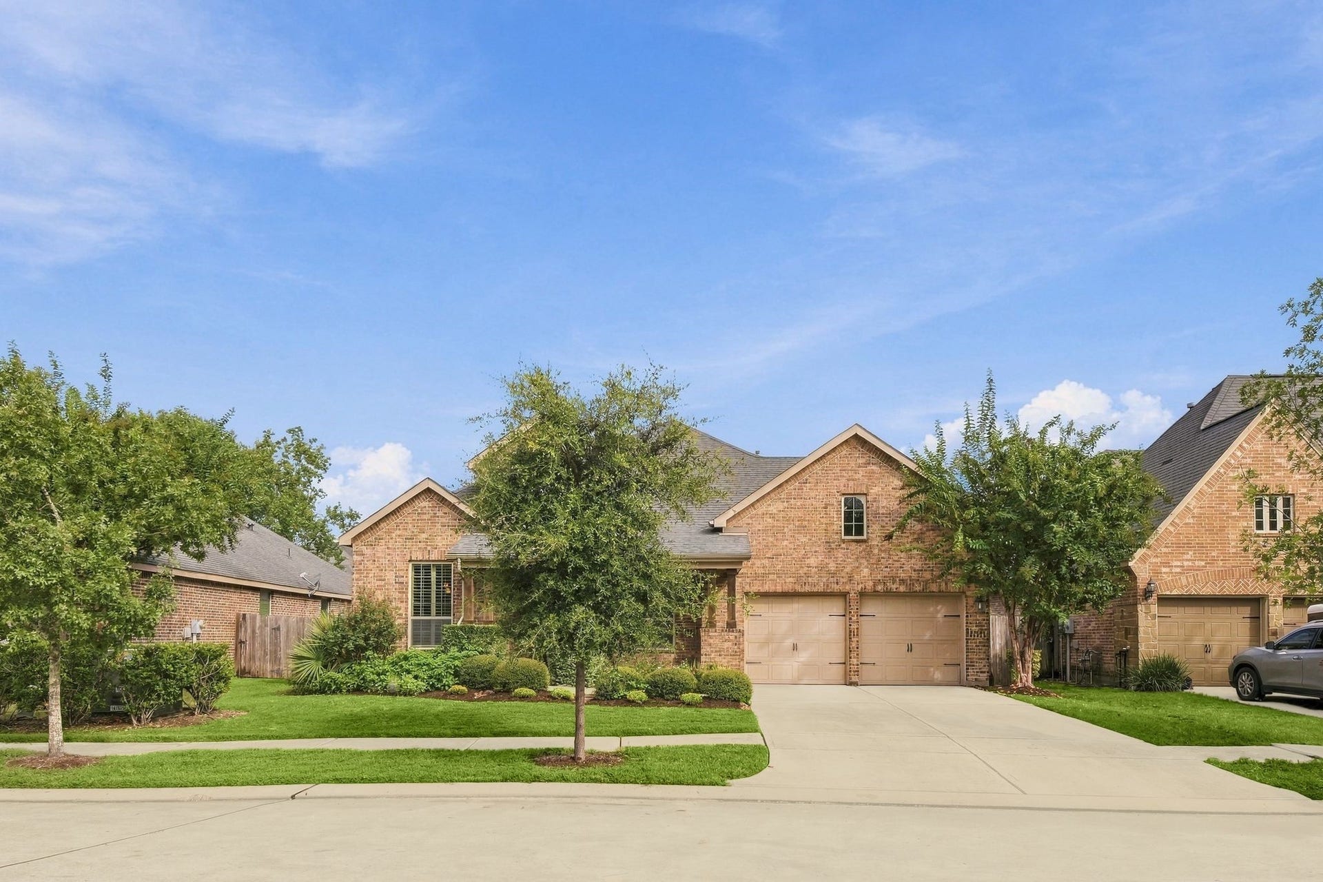 8319 Floating Heart Court, Conroe, TX 77385 Beautifully situated on a manicured homesite with a spacious front lawn.