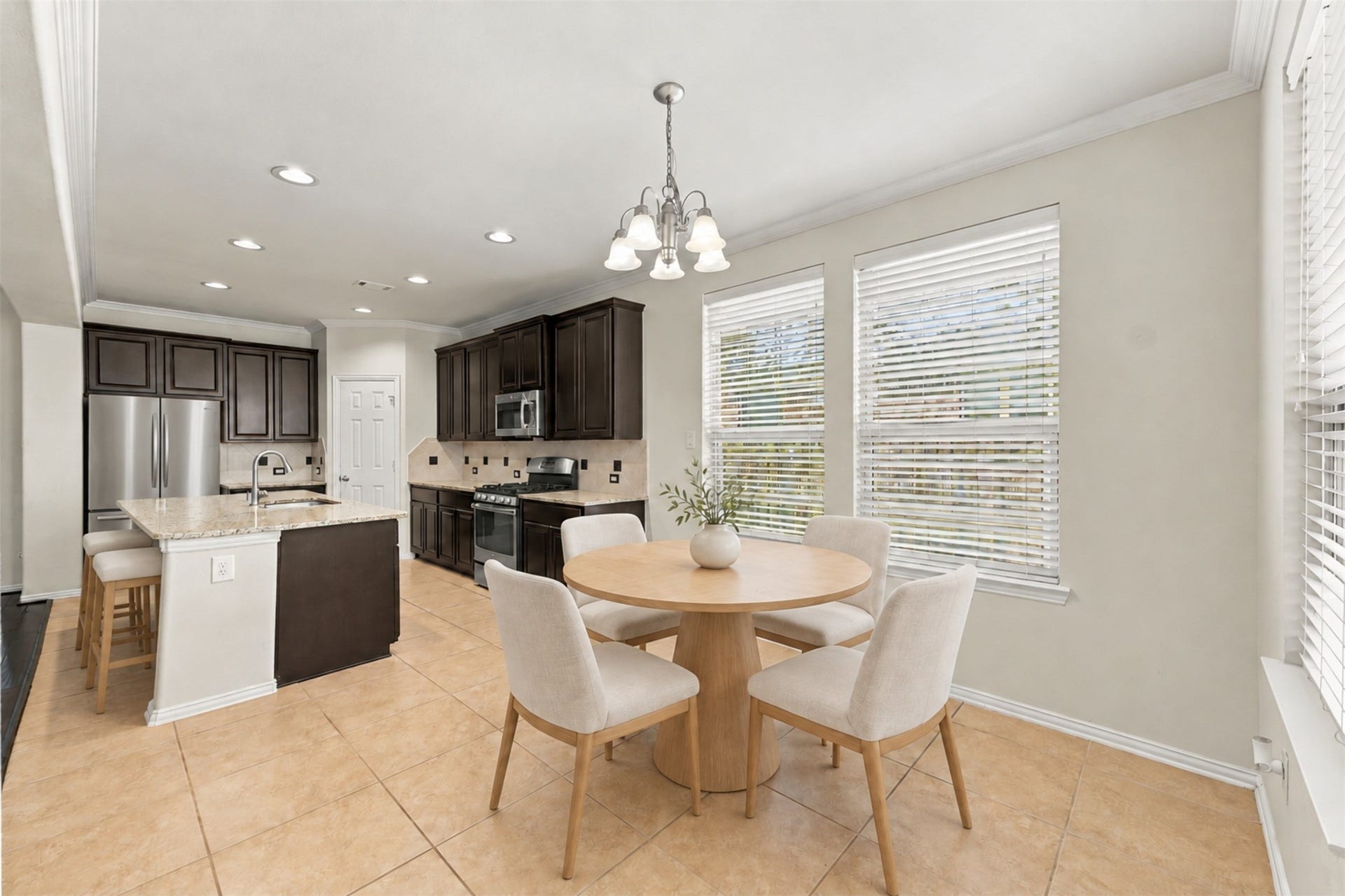 8319 Floating Heart Court, Conroe, TX 77385 Sunlit breakfast nook framed by expansive windows and open to the kitchen. *Virtually staged*