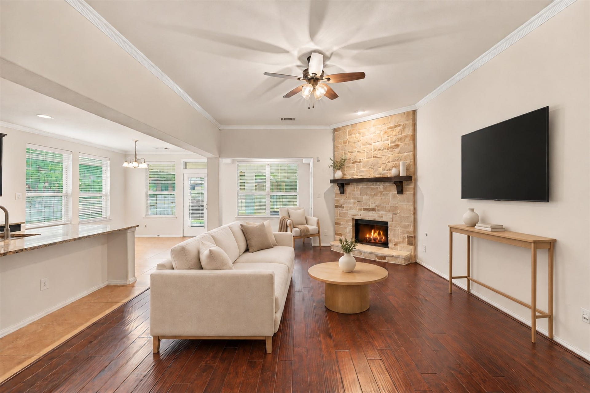 8319 Floating Heart Court, Conroe, TX 77385 Warm stone fireplace, rich hardwood floors & open-concept living. *virtually staged*