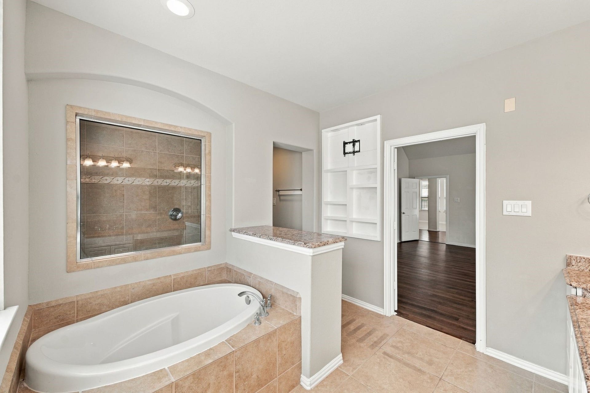 8319 Floating Heart Court, Conroe, TX 77385 A deep soaking tub creates a relaxing centerpiece within the primary bath.