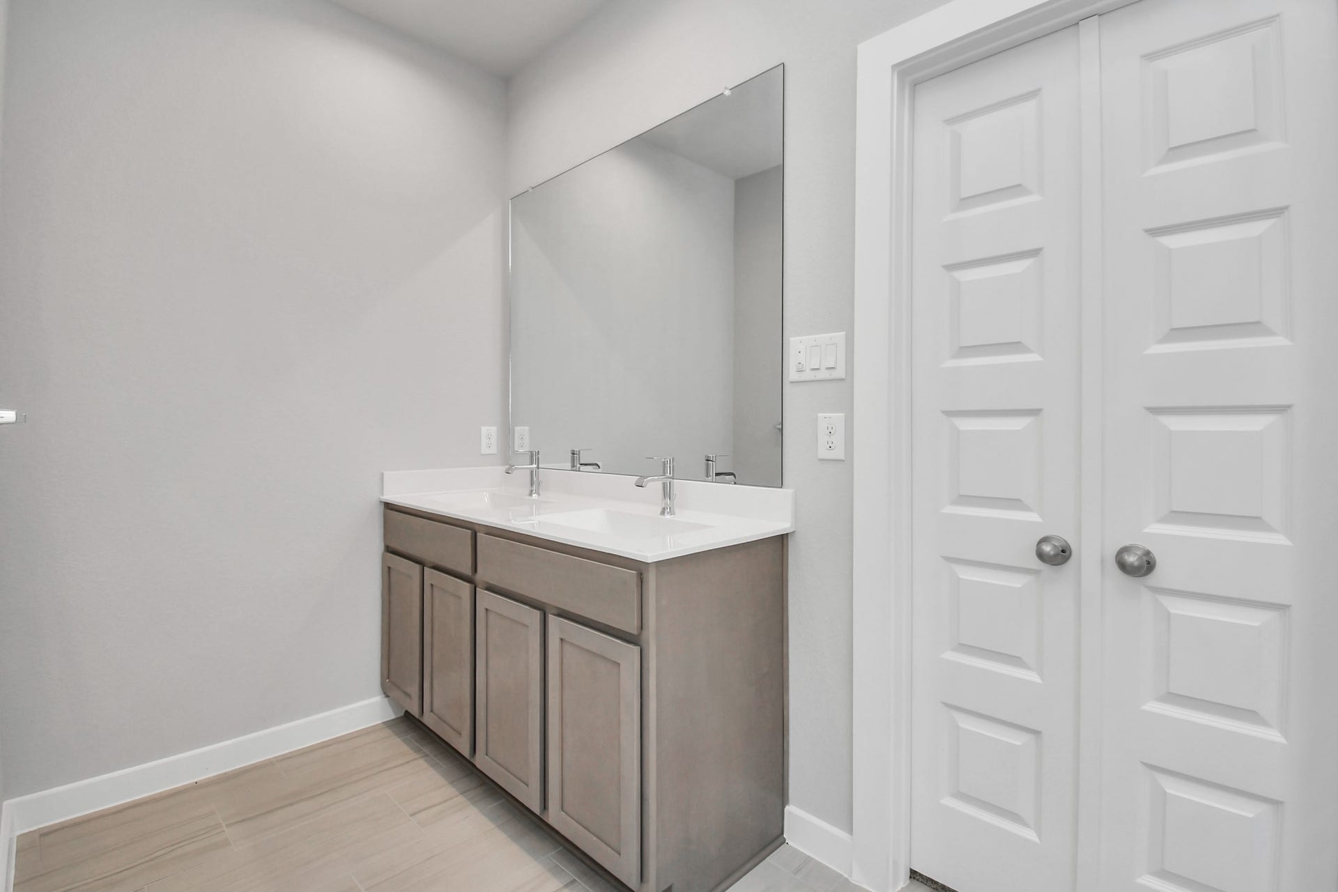 11027 Gardenia Creek Drive, Houston, TX 77044 Elevate your daily routine at the elegant vanity, now equipped with double sinks, light countertops, modern hardware, and beautiful recessed lights. Sample photo of completed home with similar floor plan. Actual colors and selections may vary.