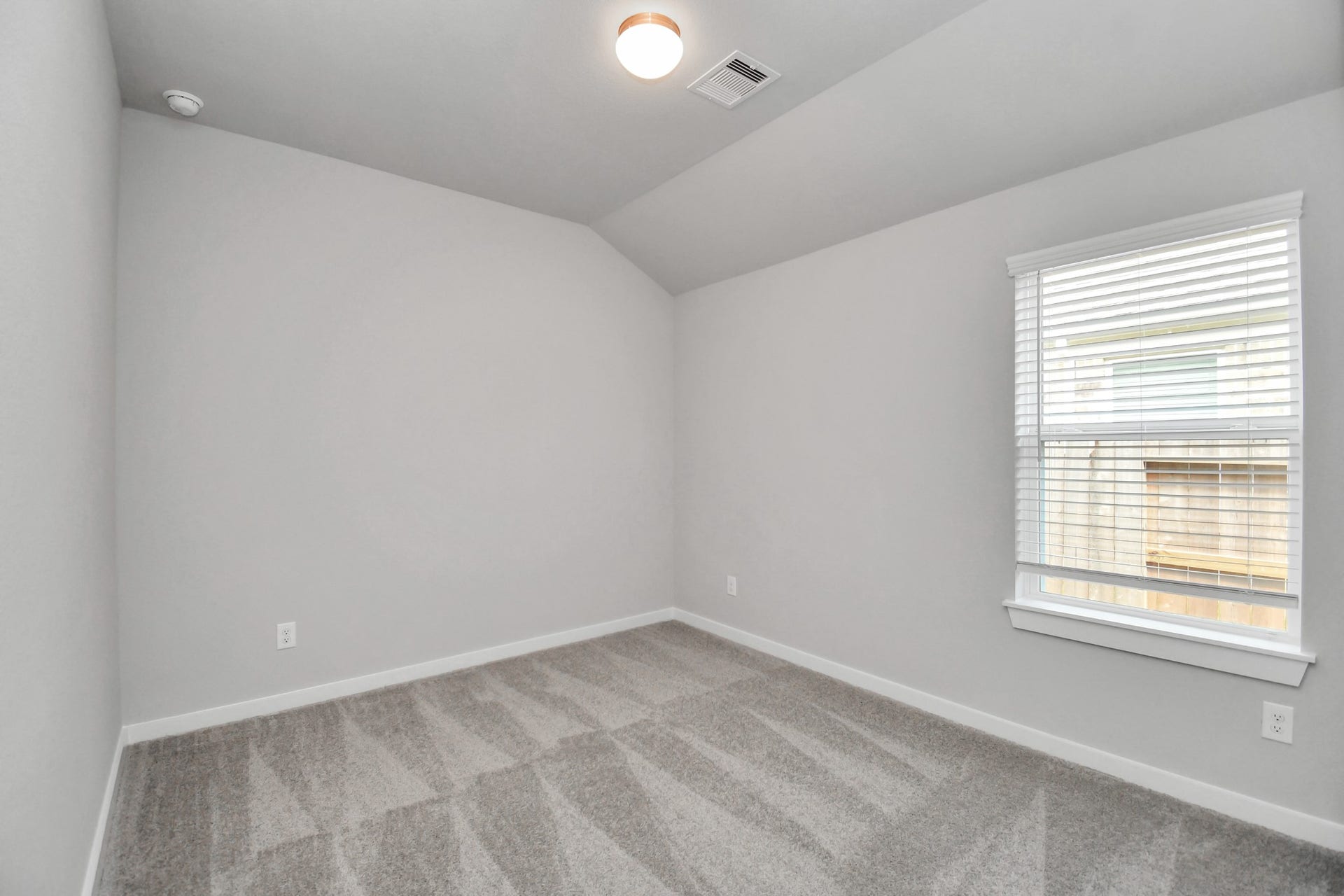 11027 Gardenia Creek Drive, Houston, TX 77044 Secondary bedroom features plush carpeting, large windows that let in plenty of natural light, bright paint, and spacious closets. Sample photo of completed home with similar floor plan. Actual colors and selections may vary.