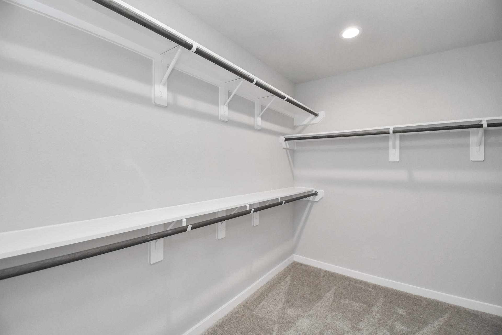 11027 Gardenia Creek Drive, Houston, TX 77044 Walk-in closet that epitomizes luxury and practicality. This generously sized space features built-in shelving, offering abundant room for impeccable organization. High ceilings and recessed lighting create a bright and welcoming ambiance. Sample photo of completed home with similar floor plan. Actual colors and selections may vary.