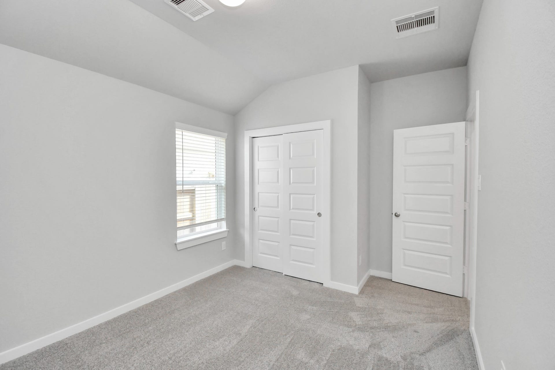 11027 Gardenia Creek Drive, Houston, TX 77044 Generously sized secondary bedrooms featuring spacious closets, soft and inviting carpeting underfoot, large windows allowing plenty of natural light, and the added touch of privacy blinds for your personal retreat. Sample photo of completed home with similar floor plan. Actual colors and selections may vary.
