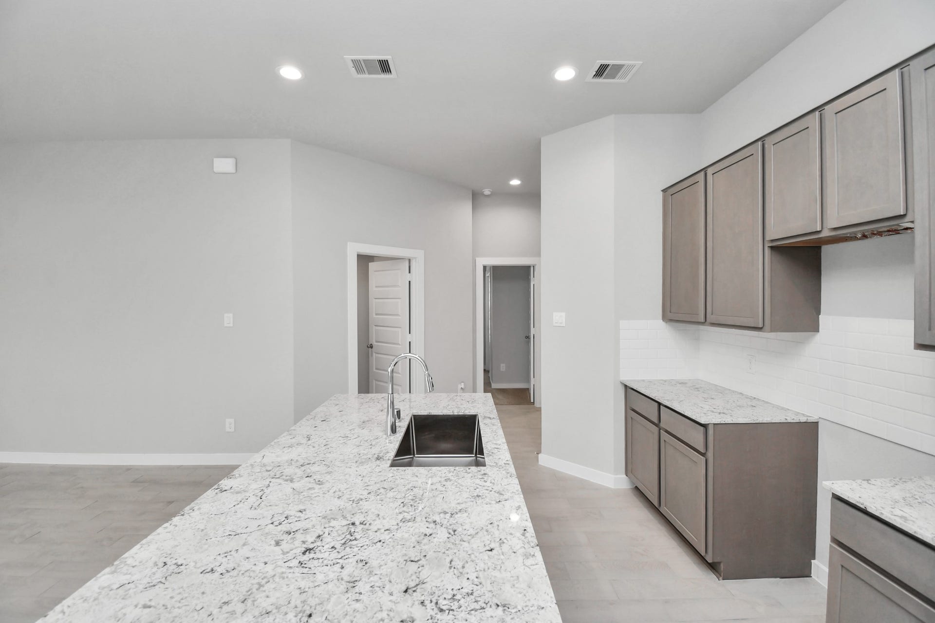 11027 Gardenia Creek Drive, Houston, TX 77044 This generously spacious kitchen is a dream realized! Sample photo of completed home with similar floor plan. Actual colors and selections may vary.