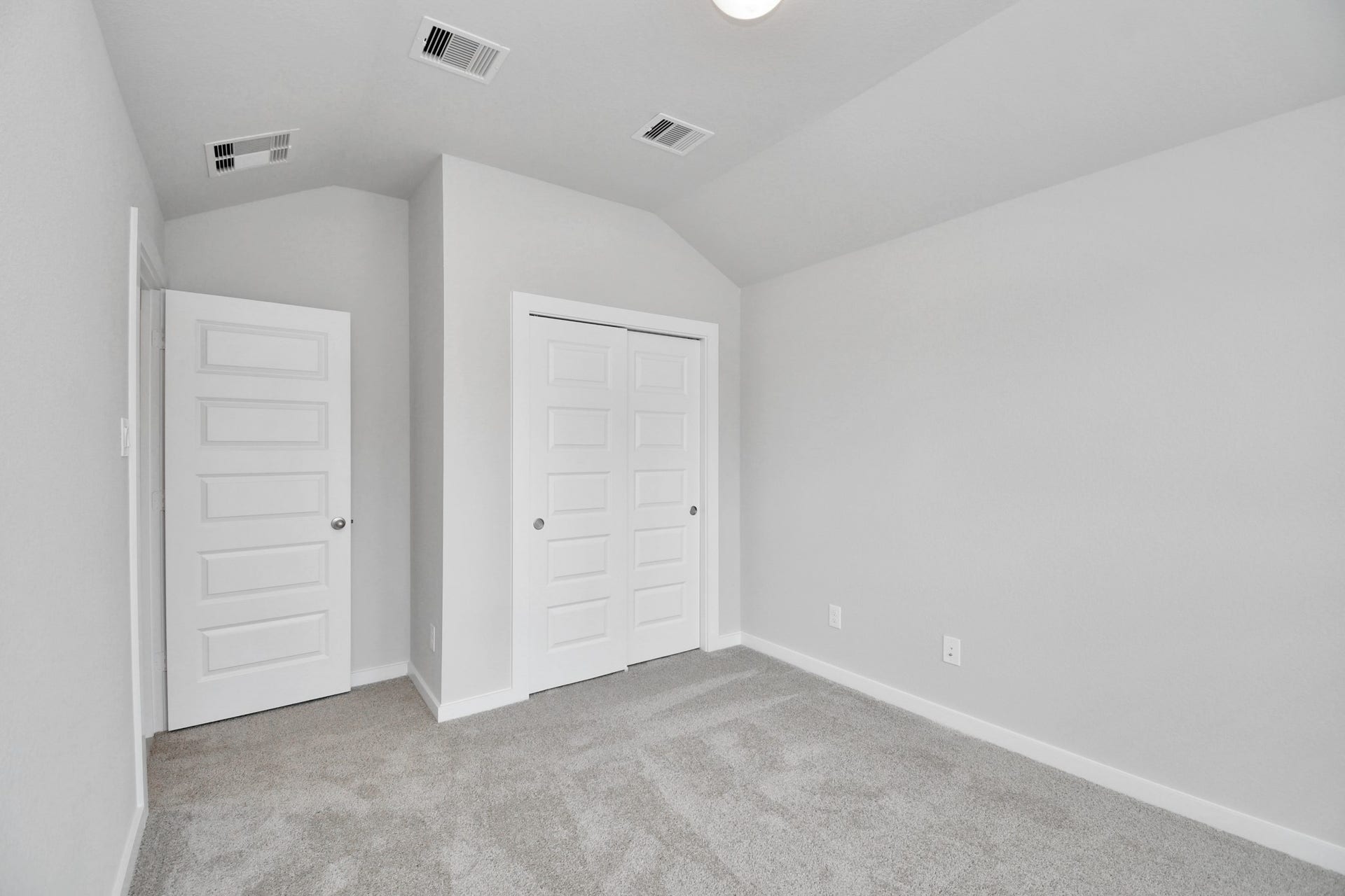 11027 Gardenia Creek Drive, Houston, TX 77044 Secondary bedroom features plush carpeting, large windows that let in plenty of natural light, bright paint, and spacious closets. Sample photo of completed home with similar floor plan. Actual colors and selections may vary.