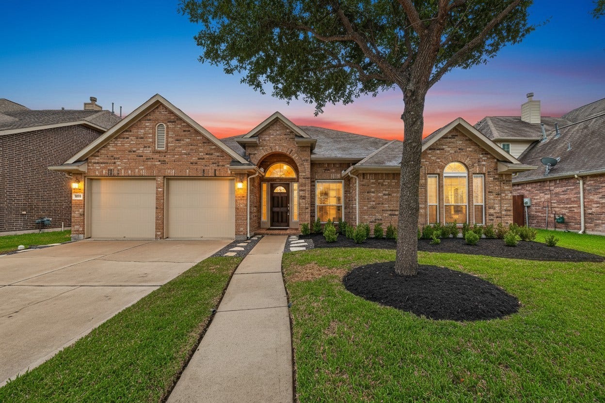 5607 Granite Falls Ln, Missouri City, TX 77459 Charming brick home with a welcoming arched entryway, manicured landscaping, and a spacious two-car garage, set against a stunning sunset backdrop.