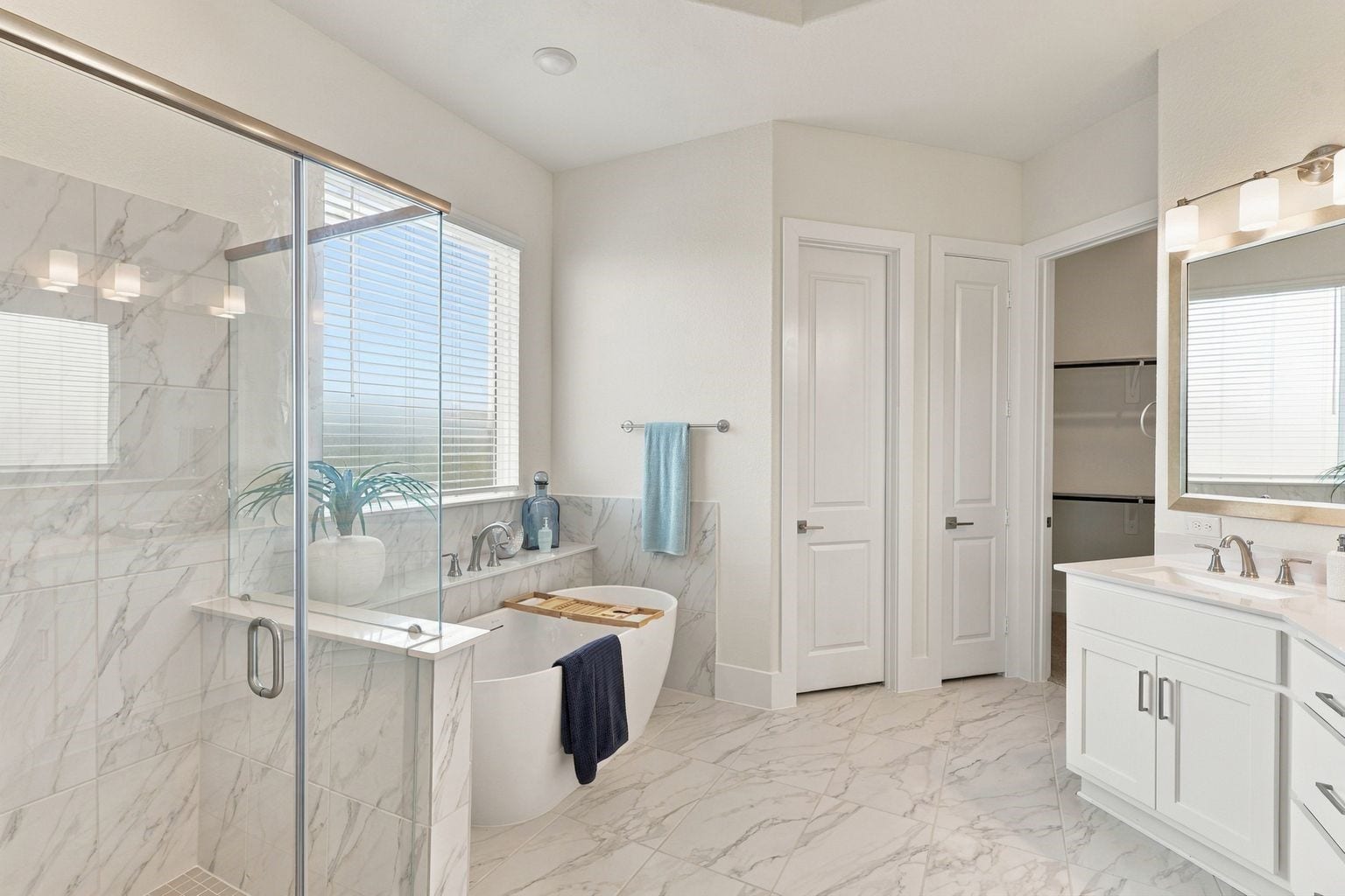 A SERENE BATHING RETREAT! Indulge in the comfort of this BEAUTIFULLY DESIGNED primary bath featuring a relaxing soaking tub, separate glass-enclosed shower, and stylish vanity cabinetry! Bright natural light and sophisticated neutral finishes enhance the spa-like atmosphere!