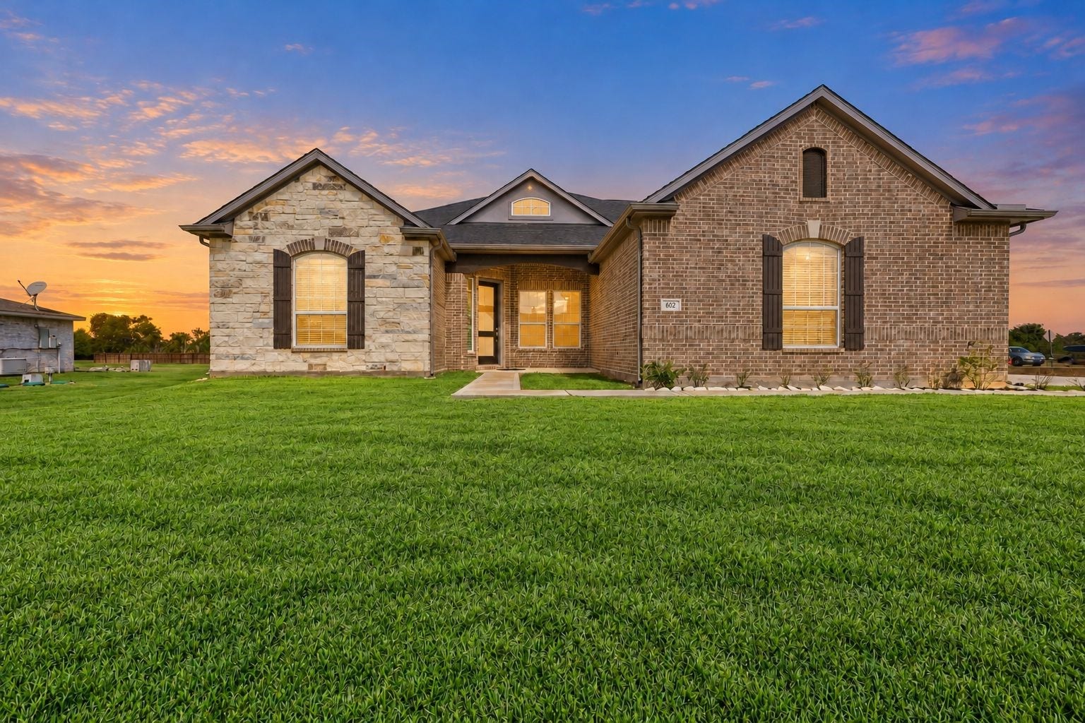 STUNNING NEW CONSTRUCTION WITH INCREDIBLE CURB APPEAL! This BEAUTIFUL CASTLEROCK COMMUNITIES HOME showcases a SPECTACULAR BRICK & STONE EXTERIOR, charming architectural details & an inviting grand entrance! Designed with ENERGY-SAVING FEATURES for modern comfort! Just LOOK at that EXPANSIVE GREEN LAWN on an IMPRESSIVE 1.163-ACRE PROPERTY! NO CROWDED LOTS OR HOMES RIGHT ON TOP OF EACH OTHER HERE! Enjoy WONDERFUL OPEN SPACE between neighboring homes, offering room to roam, garden, & more!