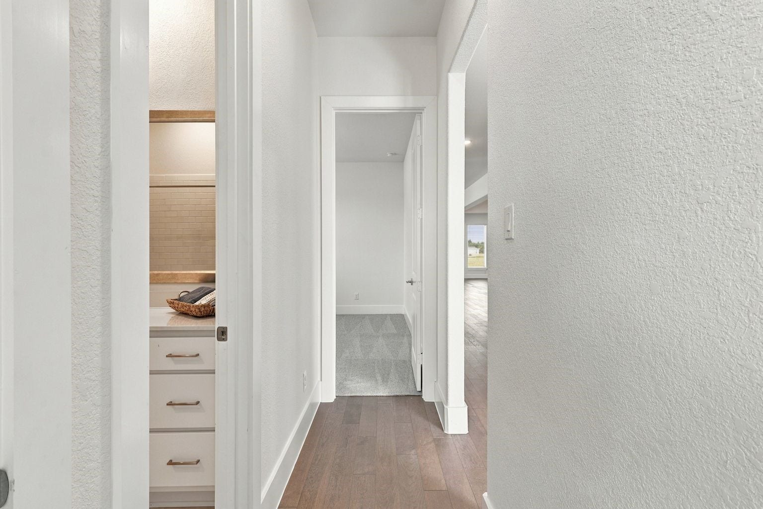 THOUGHTFULLY DESIGNED BEDROOM HALLWAY! This WELL-PLANNED layout connects the secondary bedrooms and nearby living spaces, offering convenient access and a clean, modern feel! Neutral finishes create a seamless transition between rooms while maintaining a welcoming atmosphere!