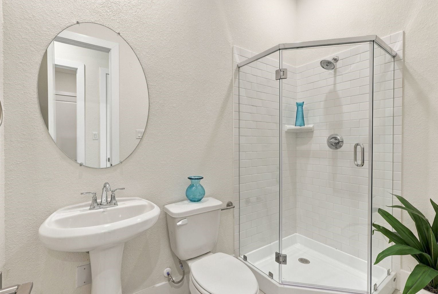 MODERN & REFRESHING BATHROOM! This STYLISH secondary bathroom features a pedestal sink, a glass-enclosed shower, contemporary fixtures, and a clean, neutral palette! A bright, functional space that combines everyday convenience with timeless appeal.