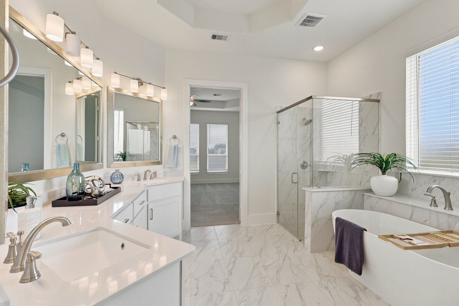 SPA-INSPIRED PRIMARY BATH! Start and end your day in this ELEGANT primary bathroom featuring his & her vanities, generous countertop space, a soaking tub, and a separate glass-enclosed shower! Bright finishes, modern fixtures, and a spacious layout create a refreshing setting for your daily routine!