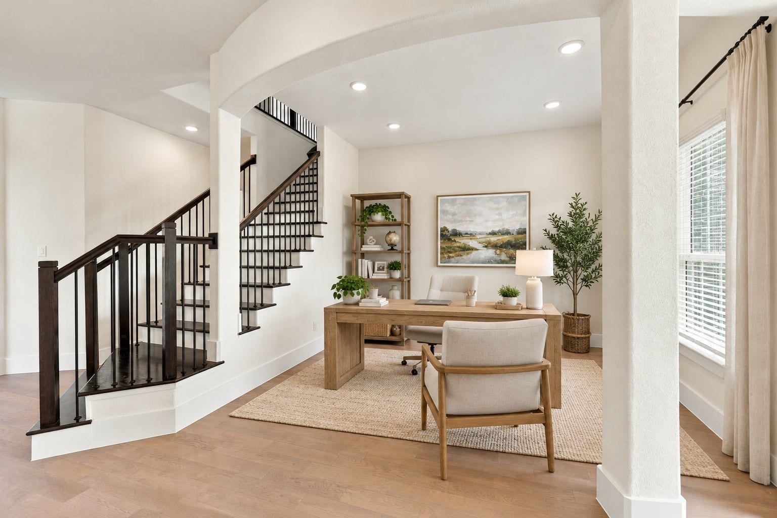 ELEGANT DESIGN & OPEN LIVING! This beautiful view highlights the virtually staged home office alongside the STRIKING STAIRCASE with dark railings, soaring ceilings, and gorgeous architectural details! The open layout offers flexibility to reimagine this space as a second sitting room or additional living area! **Photo is Virtually Staged**