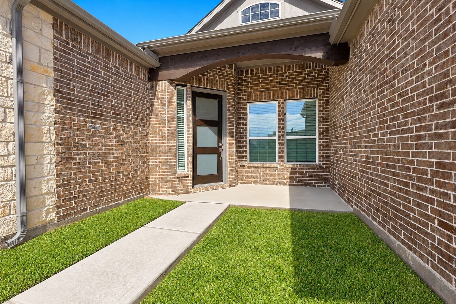 CHARMING & PRIVATE ENTRY COURTYARD! Make a wonderful first impression with this inviting entry featuring beautiful brick and stone accents, a stylish front door, and a charming courtyard-style setting! A welcoming architectural detail that adds character and appeal to this beautiful new-construction home!