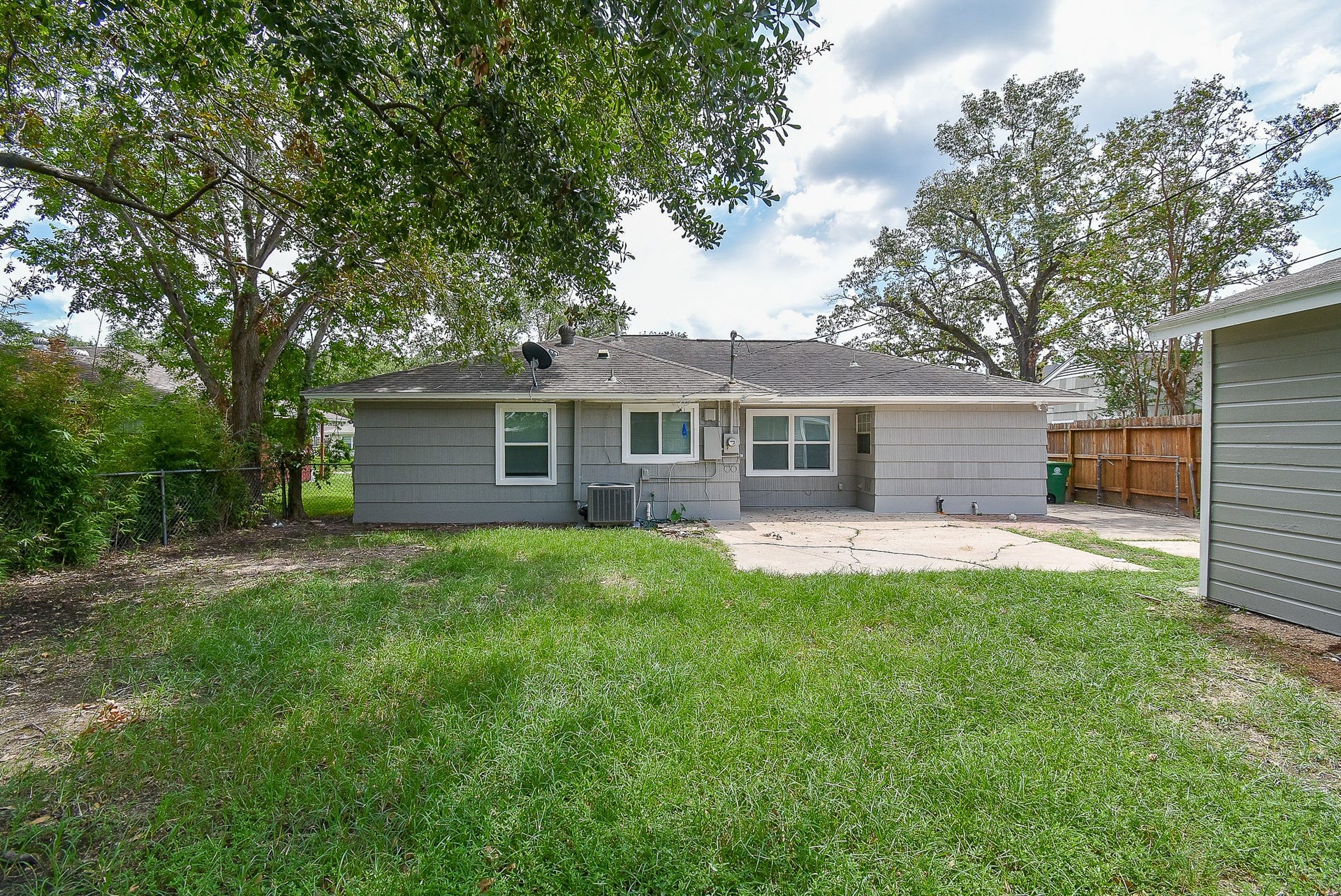 7406 Schiller Street, Houston, TX 77055 Backyard with overhead shade tree.