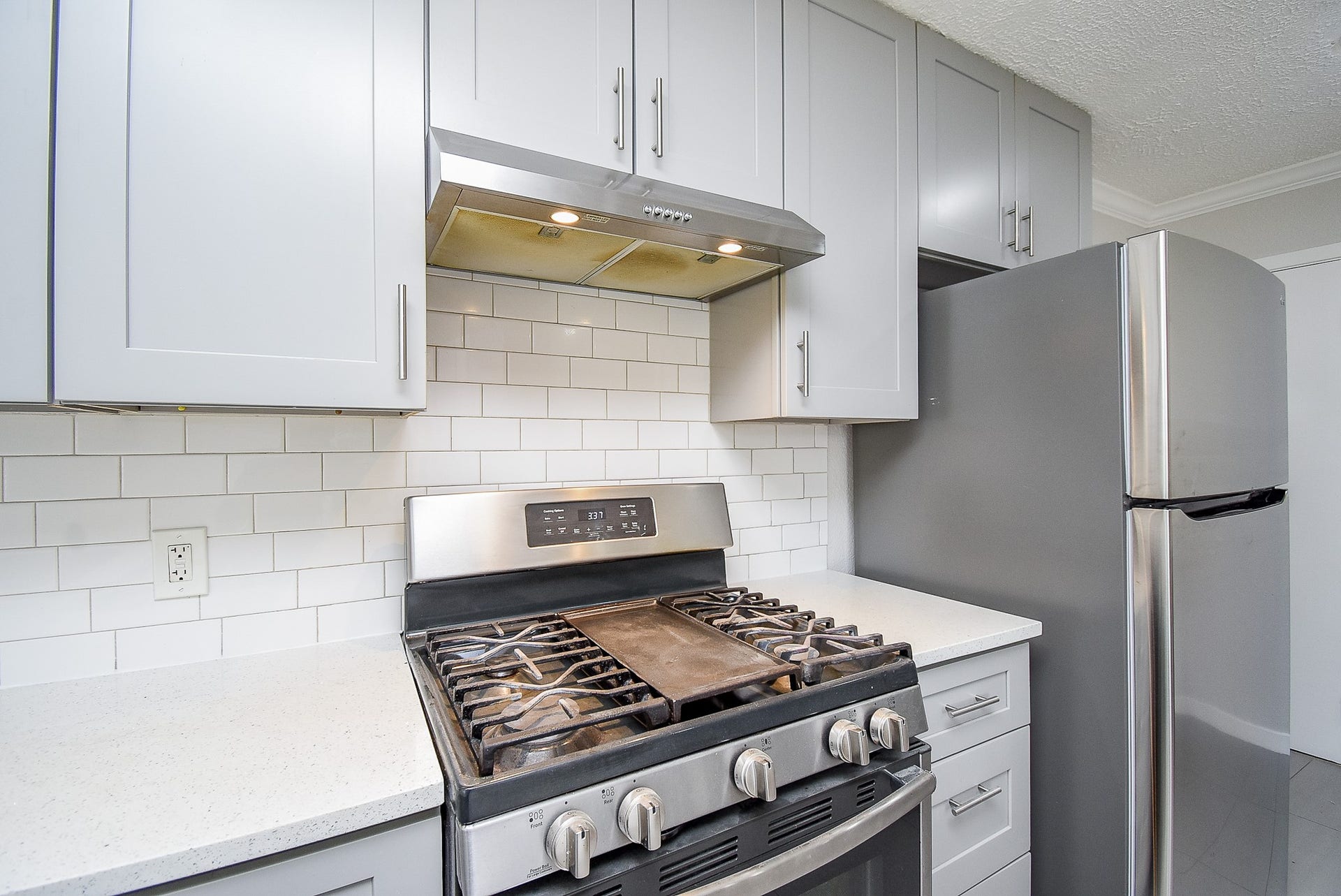 7406 Schiller Street, Houston, TX 77055 Gas oven with overhead vent fan.