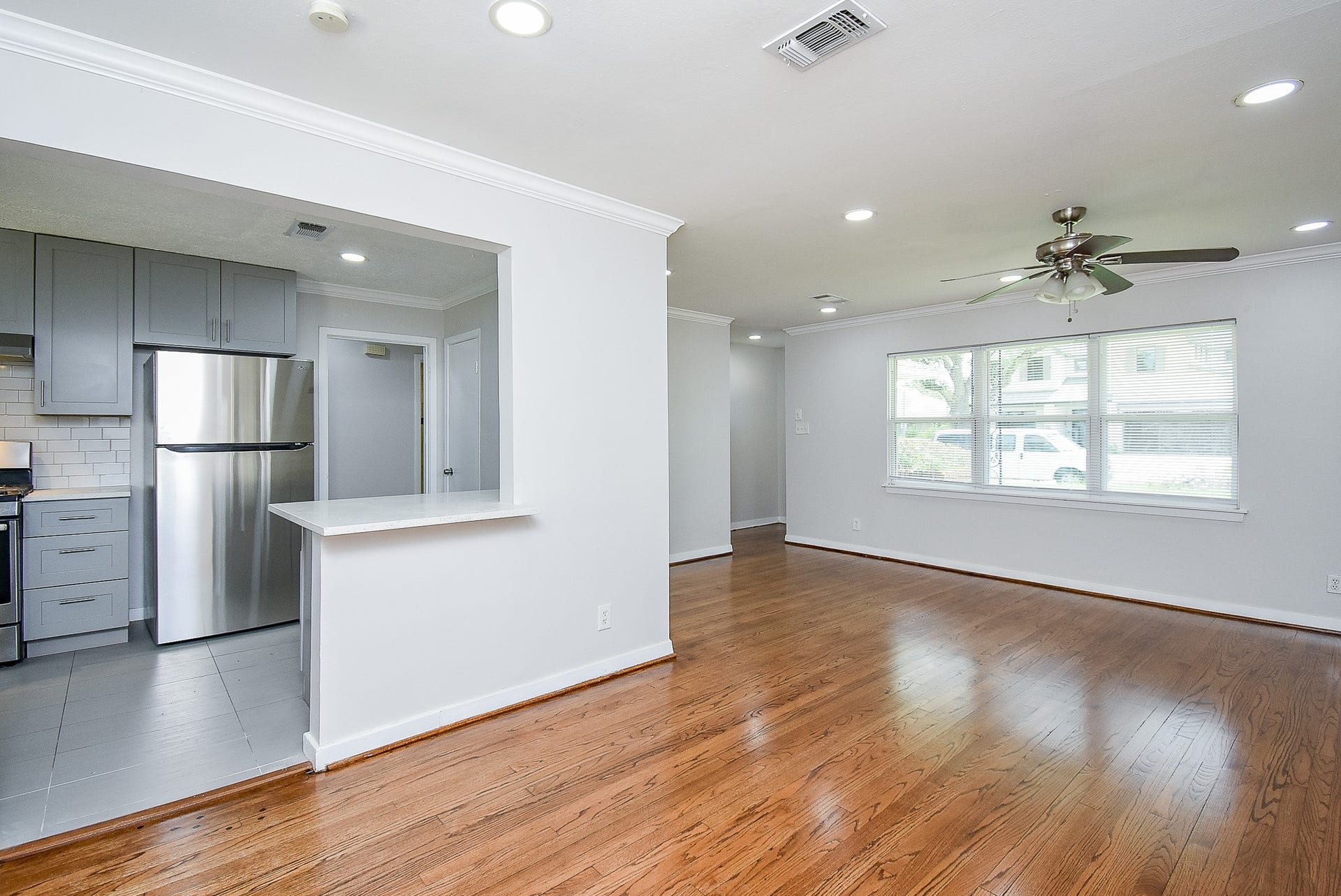 7406 Schiller Street, Houston, TX 77055 Massive living space with wood floors, recessed lighting and ceiling fan.