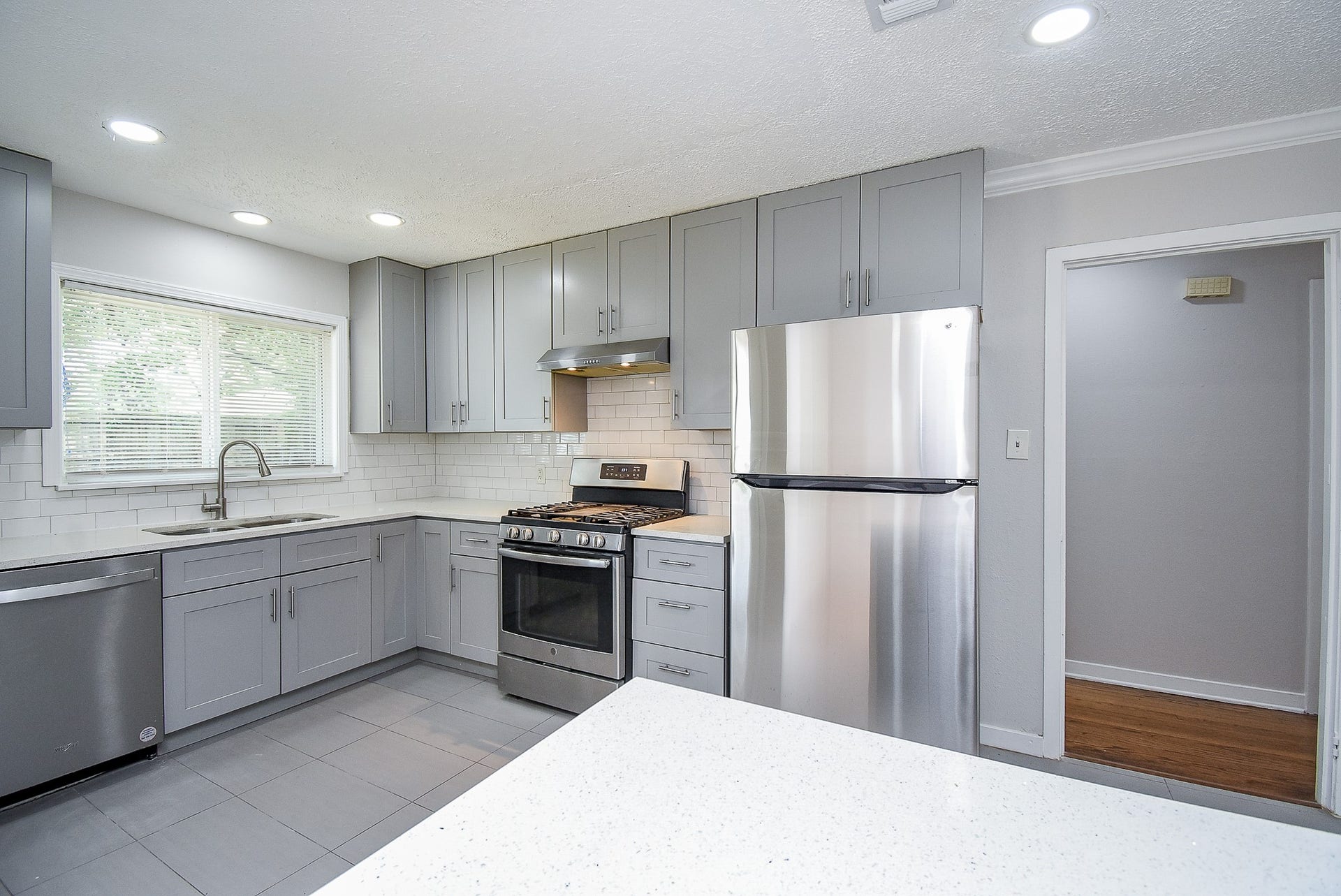 7406 Schiller Street, Houston, TX 77055 Gas stove, recessed lighting and sleek brushed nickel cabinet pulls.