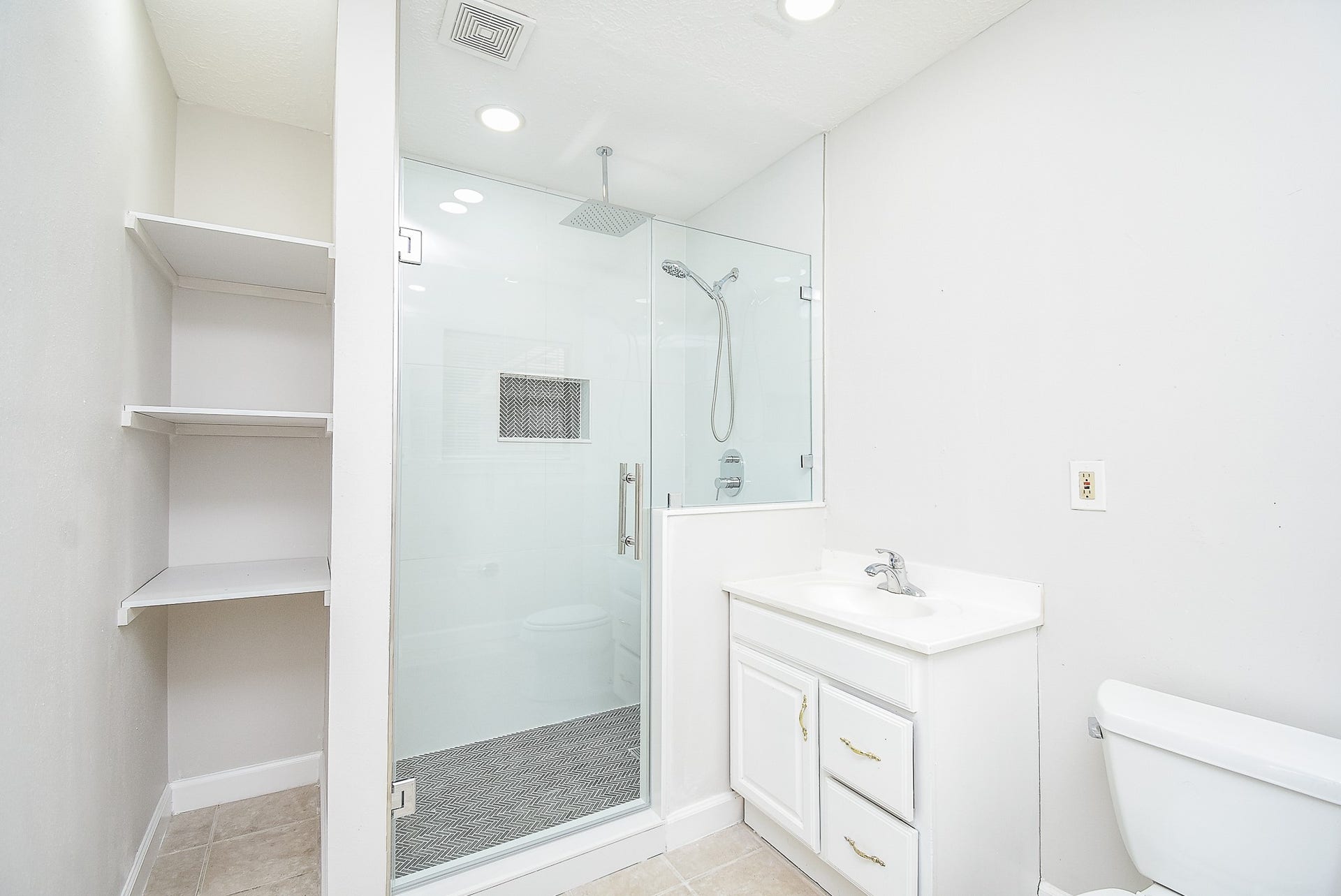 7406 Schiller Street, Houston, TX 77055 Full bathroom with glass shower door and overhead rain shower faucet.