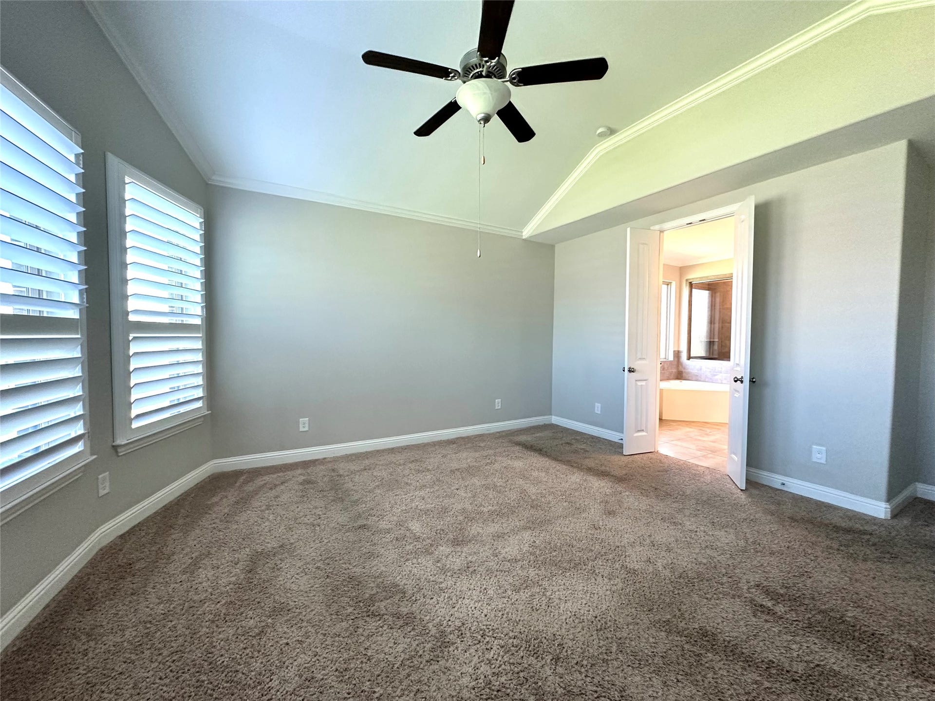 Primary bedroom with ceiling fan