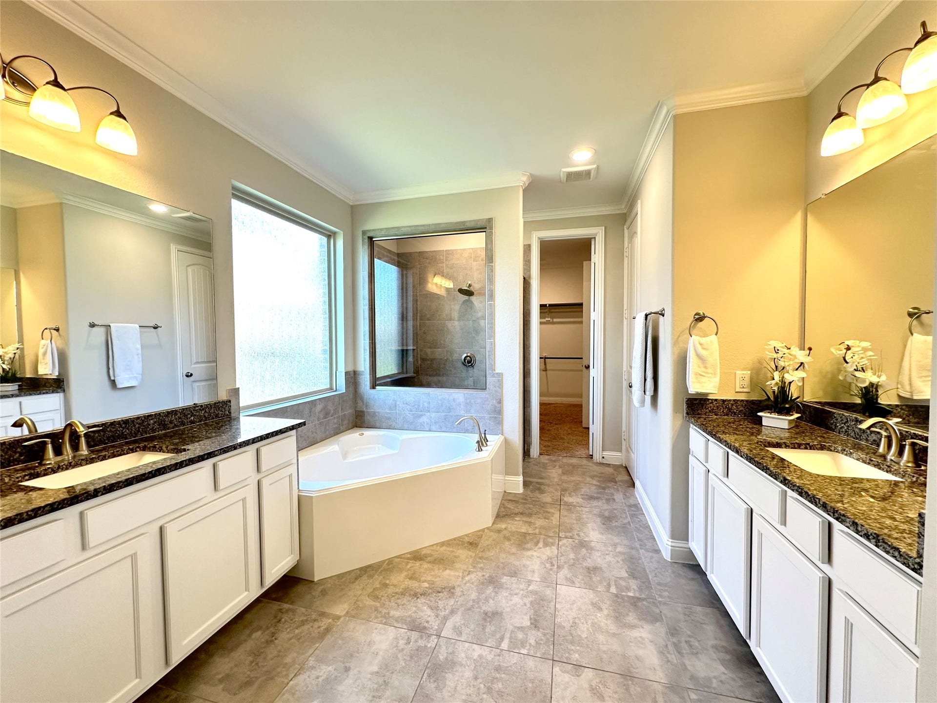 Primary bathroom with double sinks and elegant separated shower from bath tub.