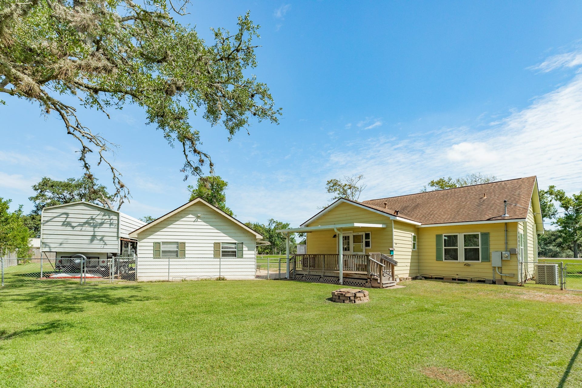View of the back of the home, oversized detached garage and RV Carport.
